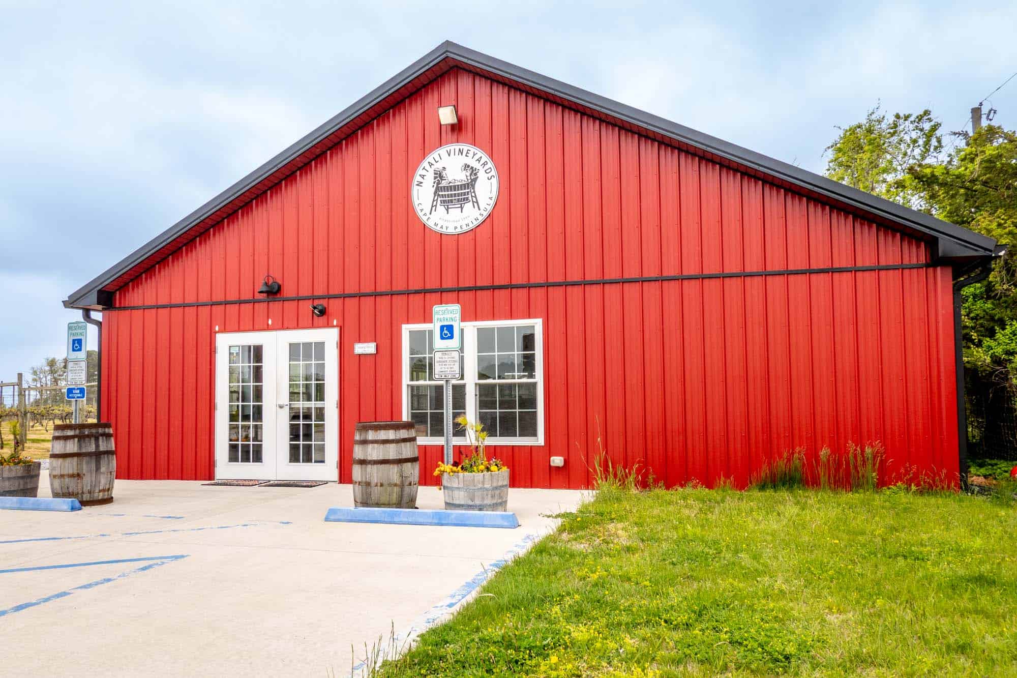 Red tasting room with a white sign for "Natali Vineyards, Cape May Peninsula."