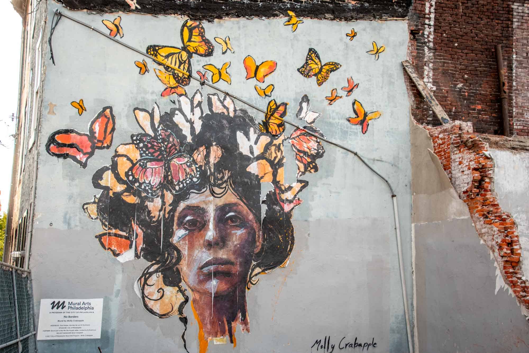 Mural of woman's face with butterflies around her head