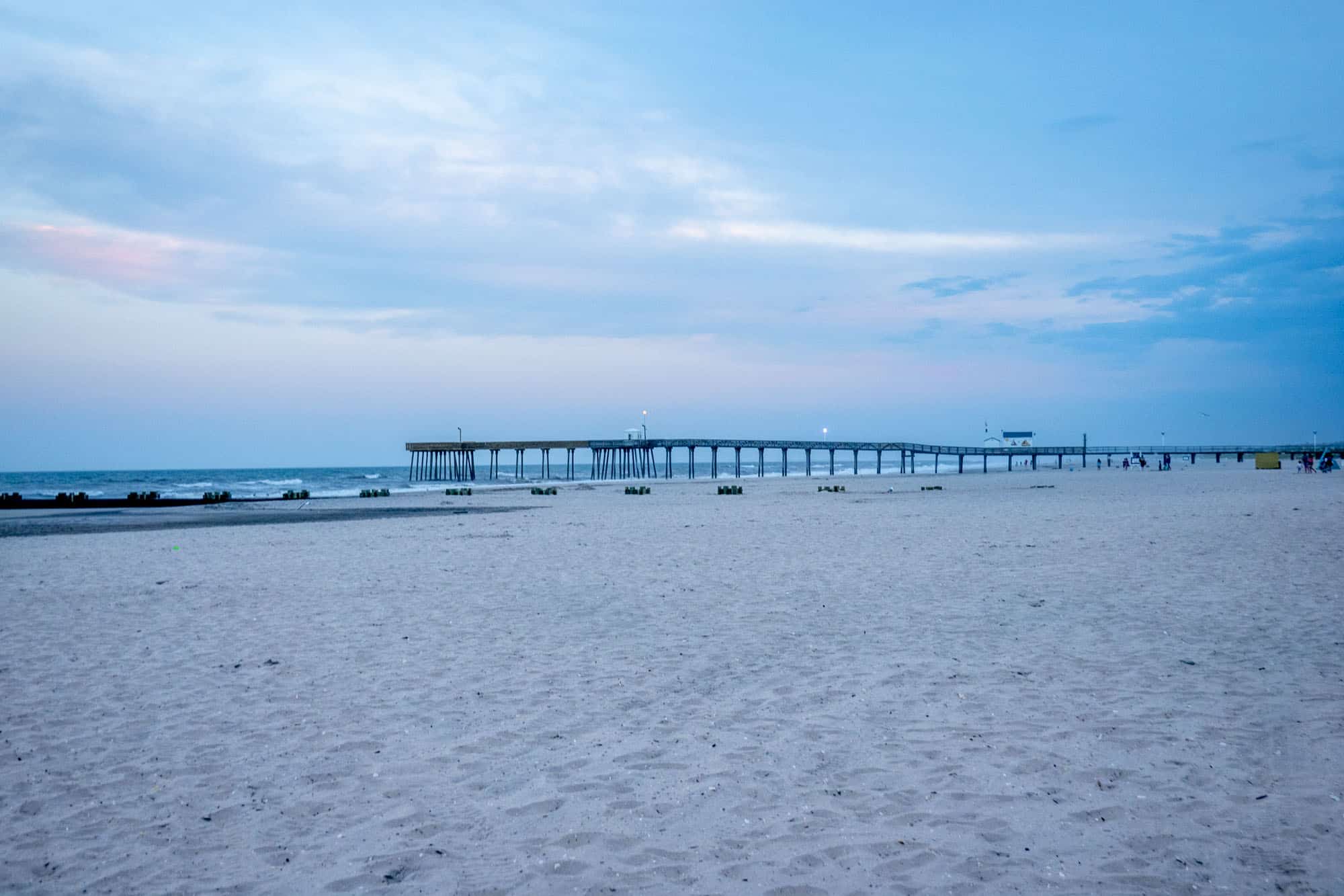 Fishing pier above the sand