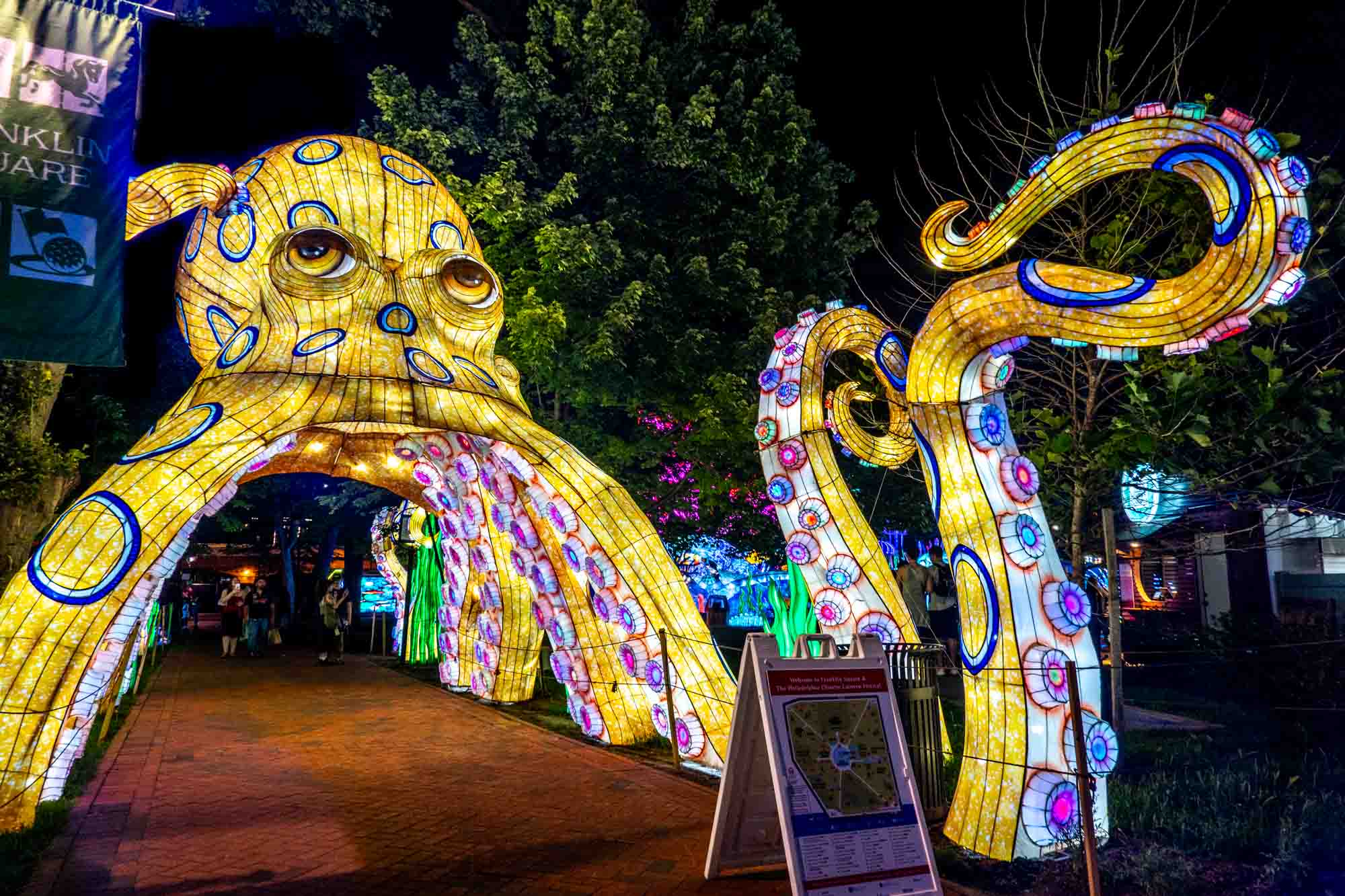 Lantern shaped like a giant octopus with tentacles lit up at night.