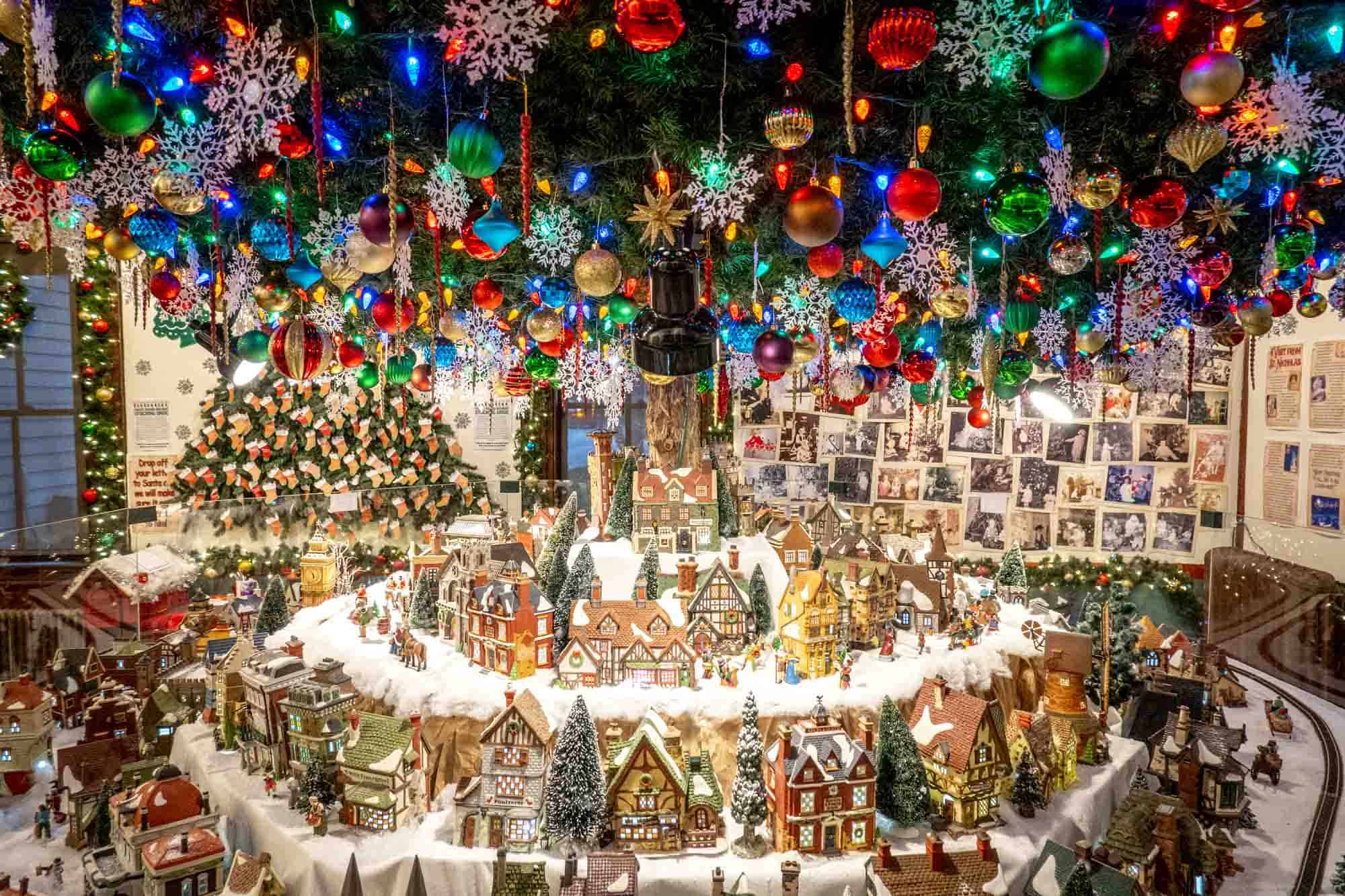 Exhibit featuring Christmas ornaments and miniature houses.