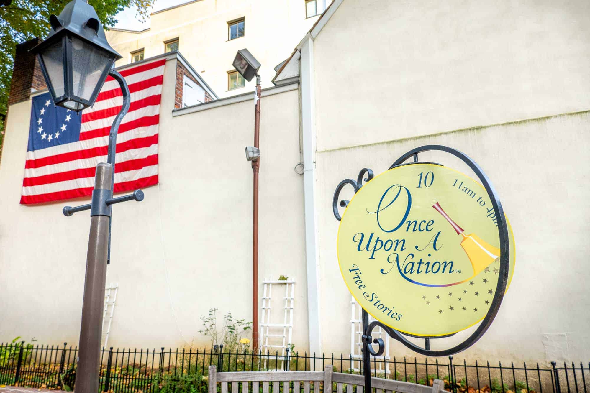 Bench with a sign: "Once Upon A Nation. Free Stories. 11am to 4pm."