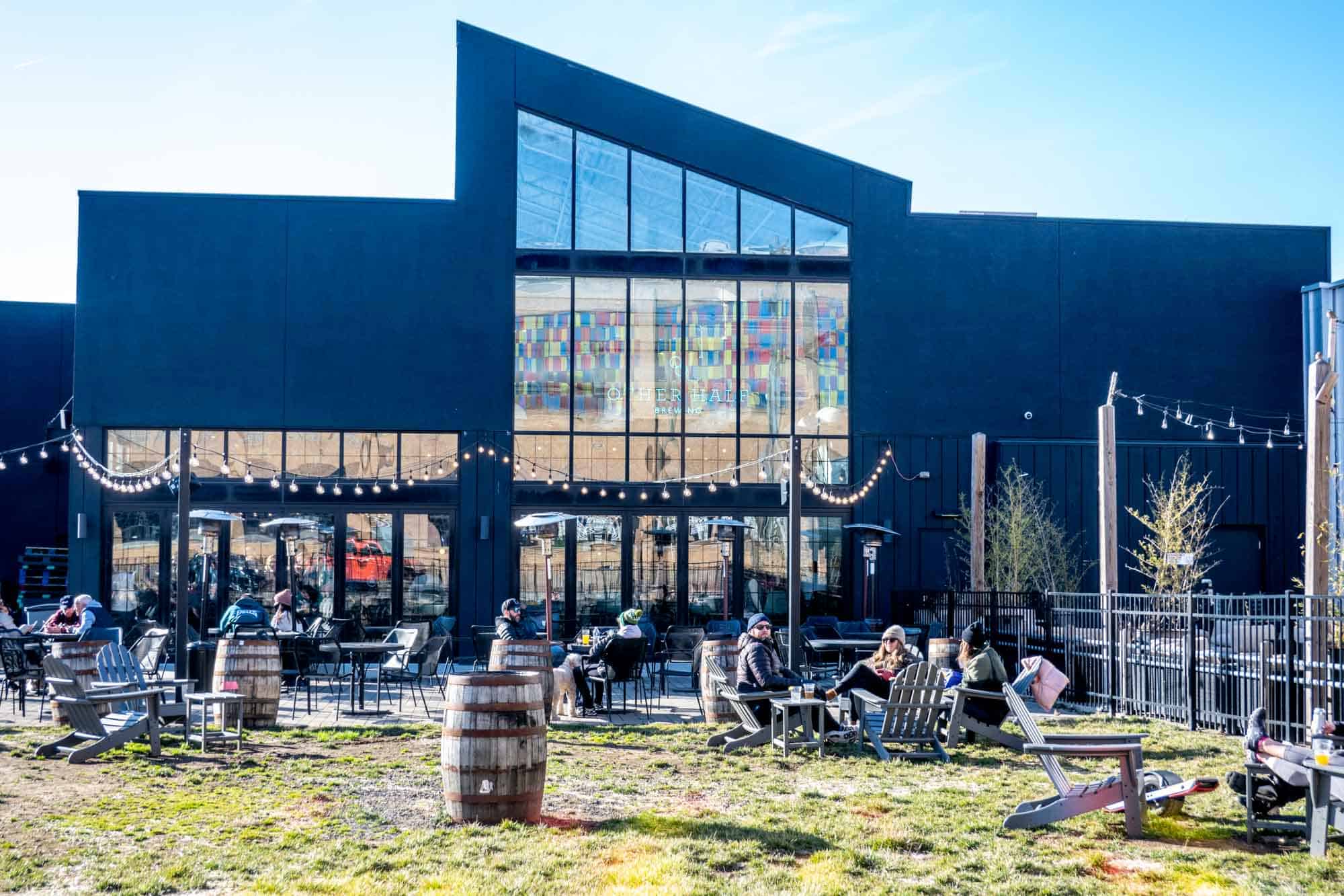 People in deck chairs outside Other Half Brewery beer garden.