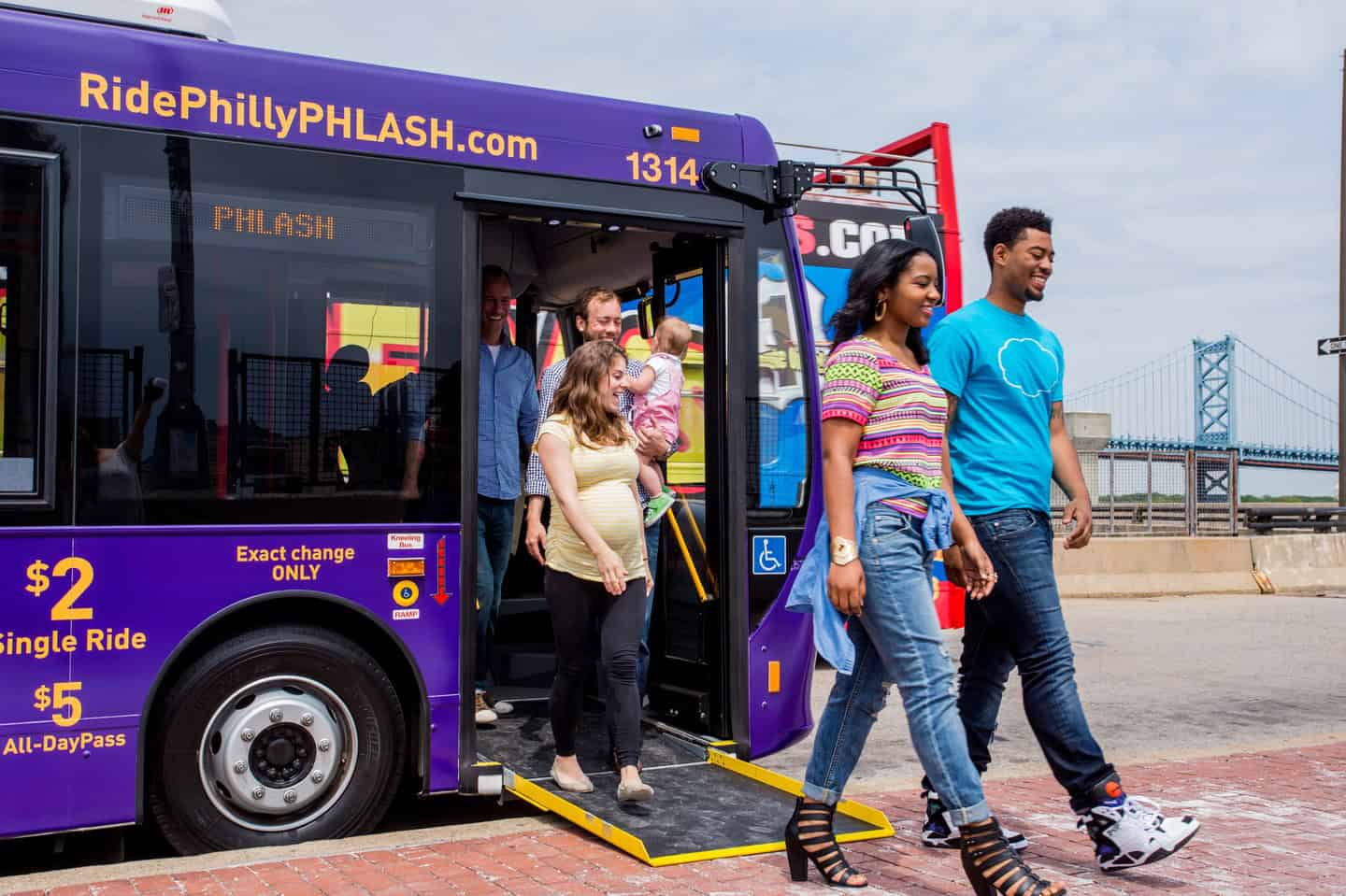 People walking off a bus/