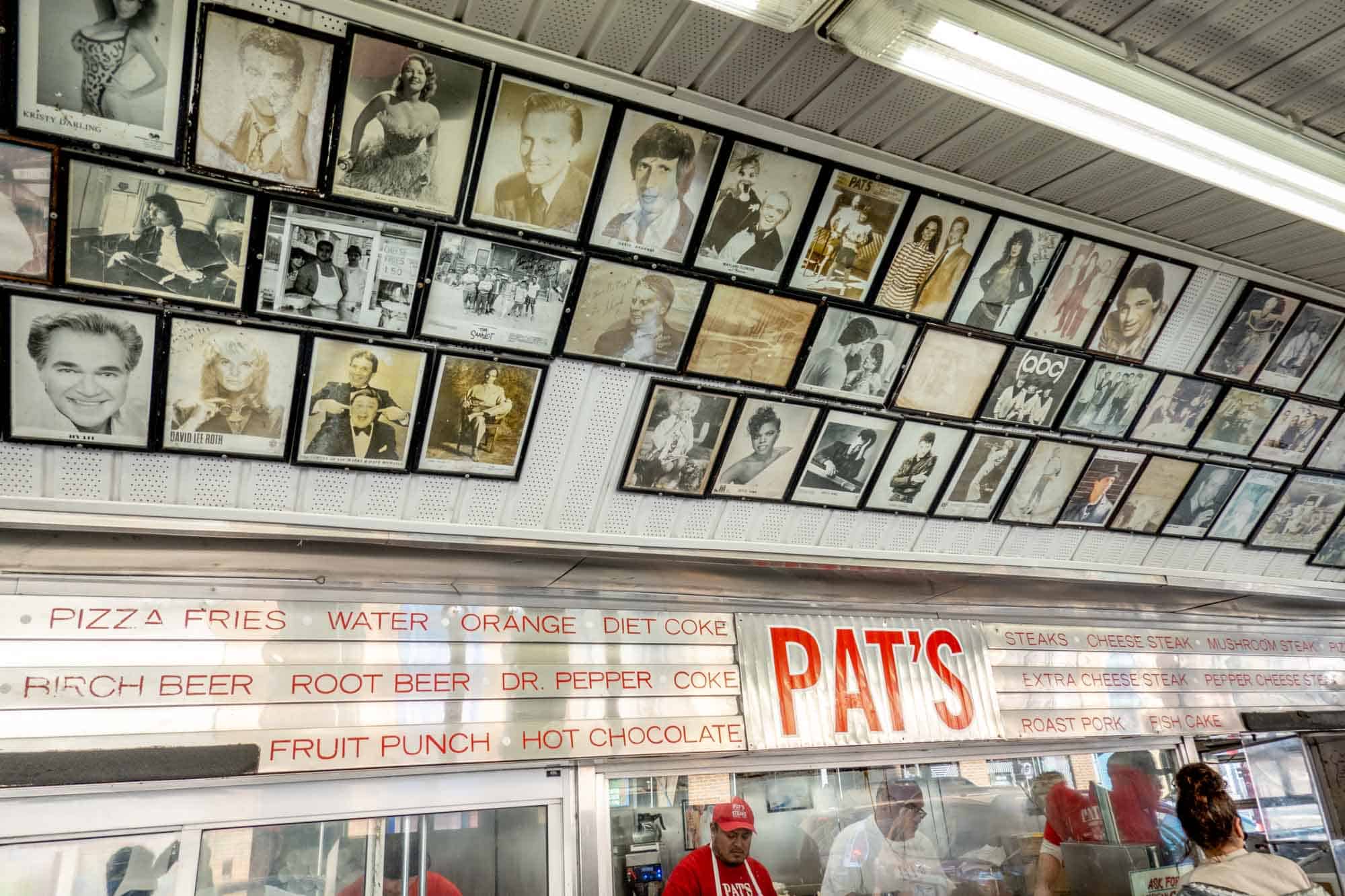 Photos of celebrities on the wall above the ordering counter at Pat's cheesesteaks.