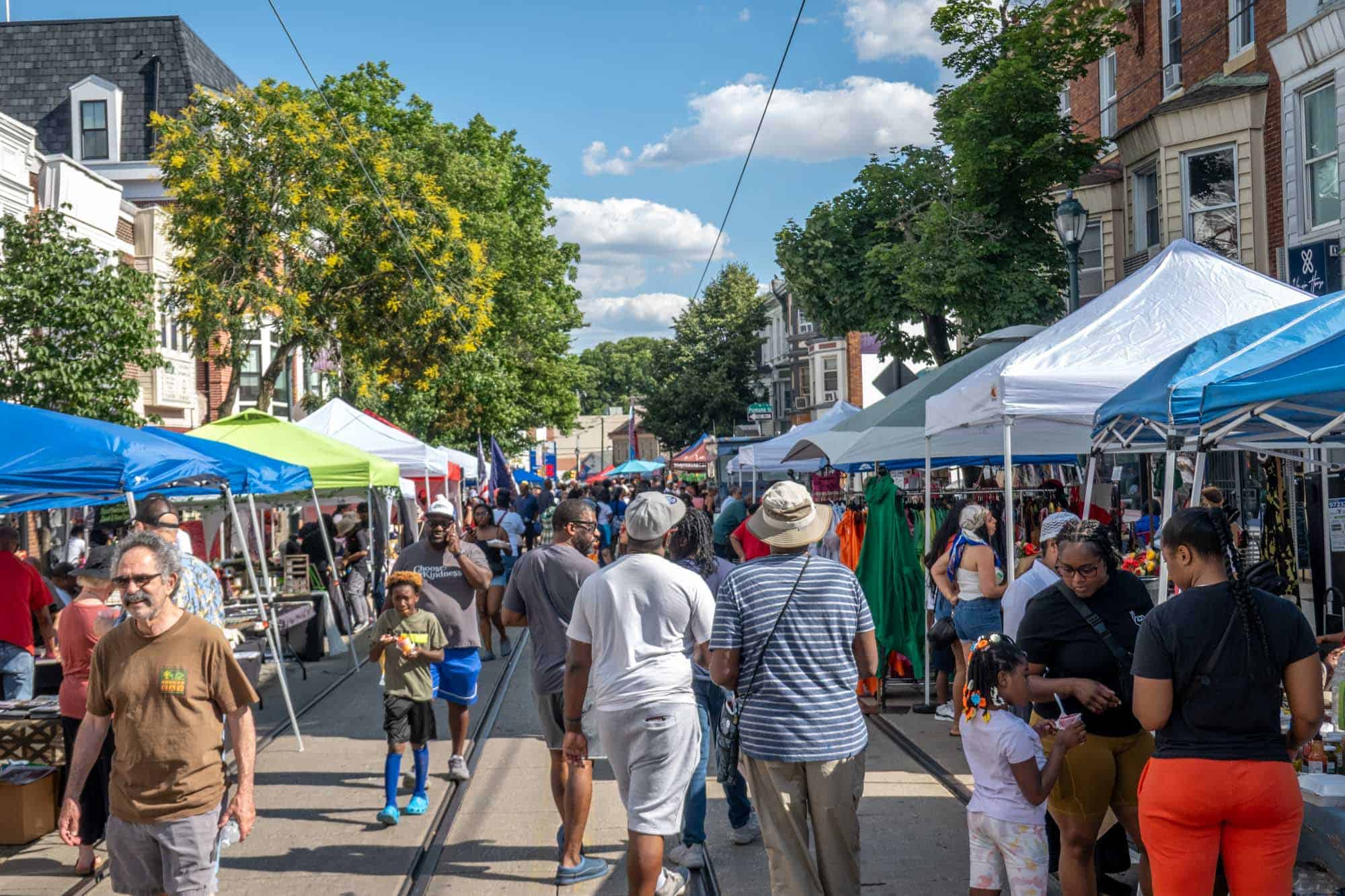People and vendors at a street festival.