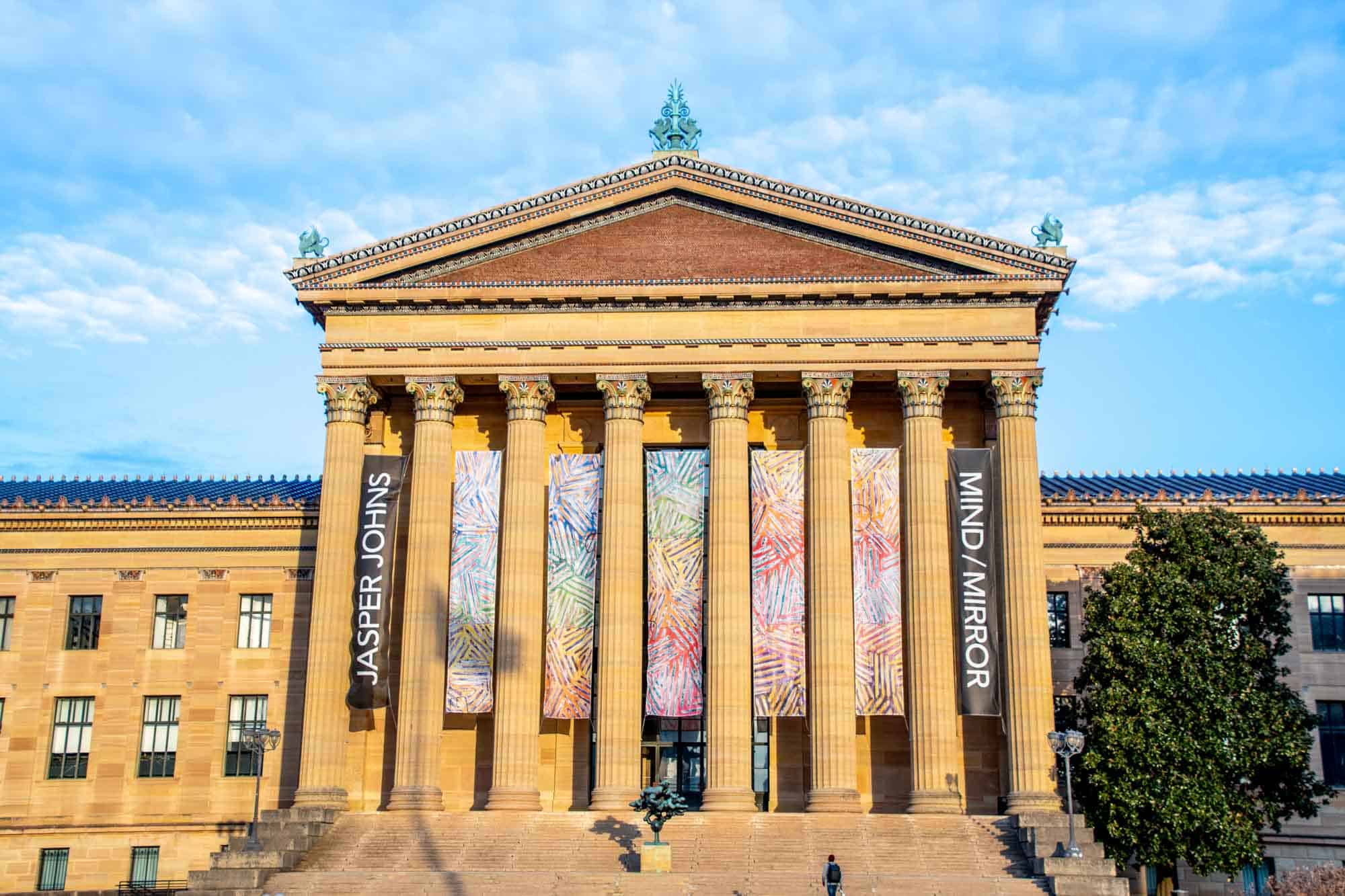 Gold colored buildings with large columns.