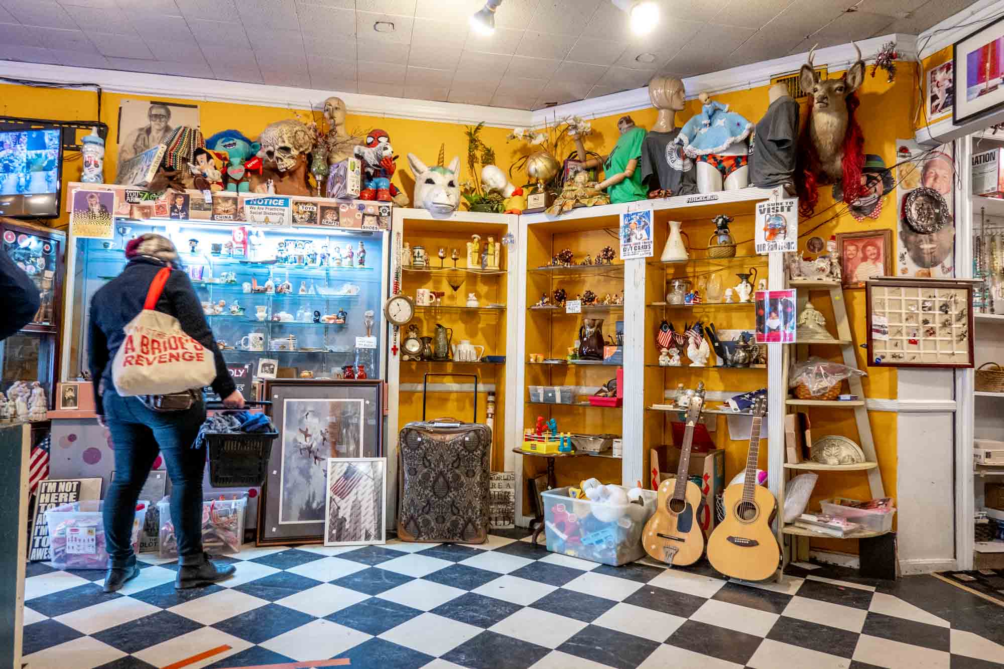 Wall covered in display case inside of a thrift store