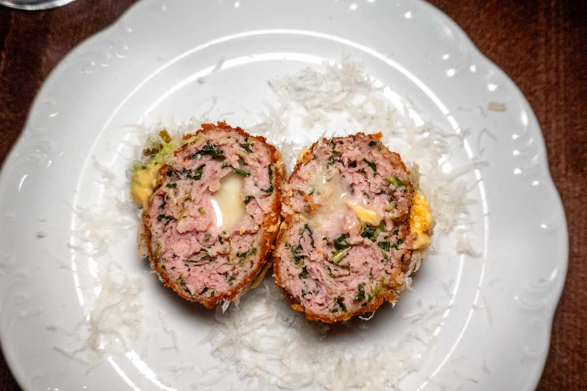 Croquette of roast pork and broccoli rabe with cheese cut in half