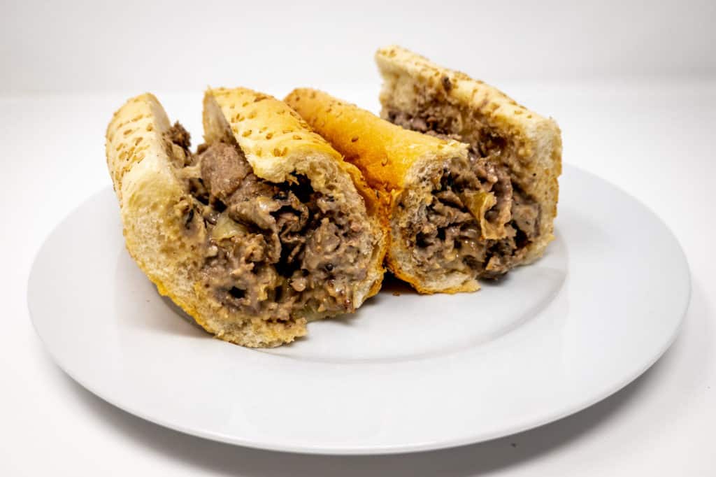 Cheesesteak in a roll on a plate
