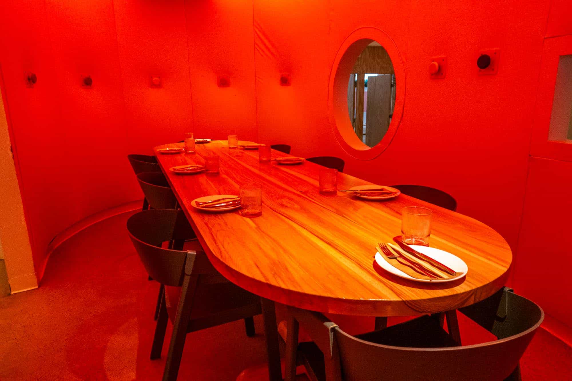 Private dining pod with red lighting