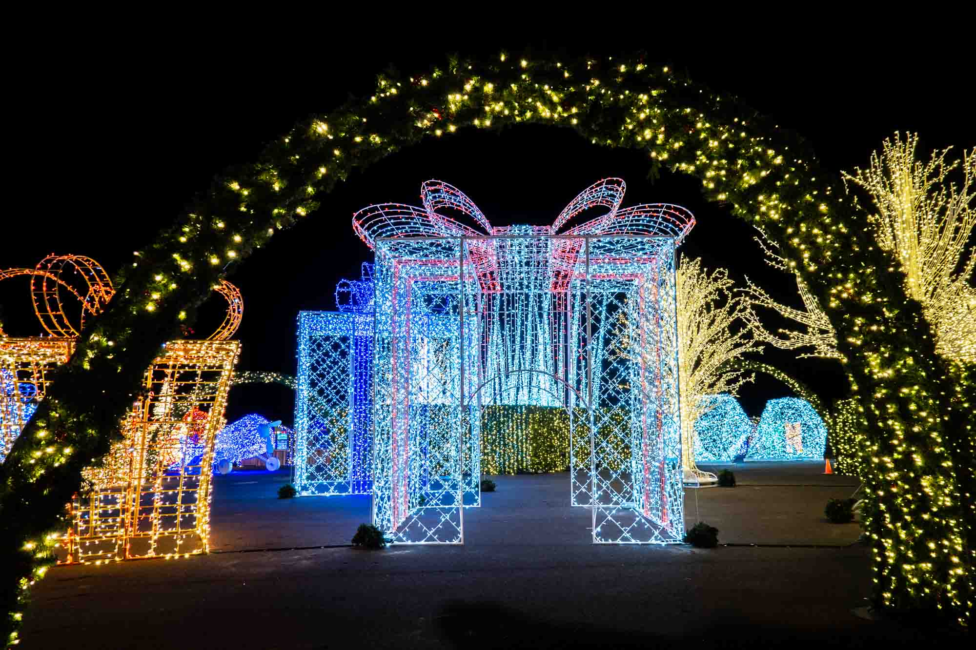 Giant, illuminated present packages at a light display.