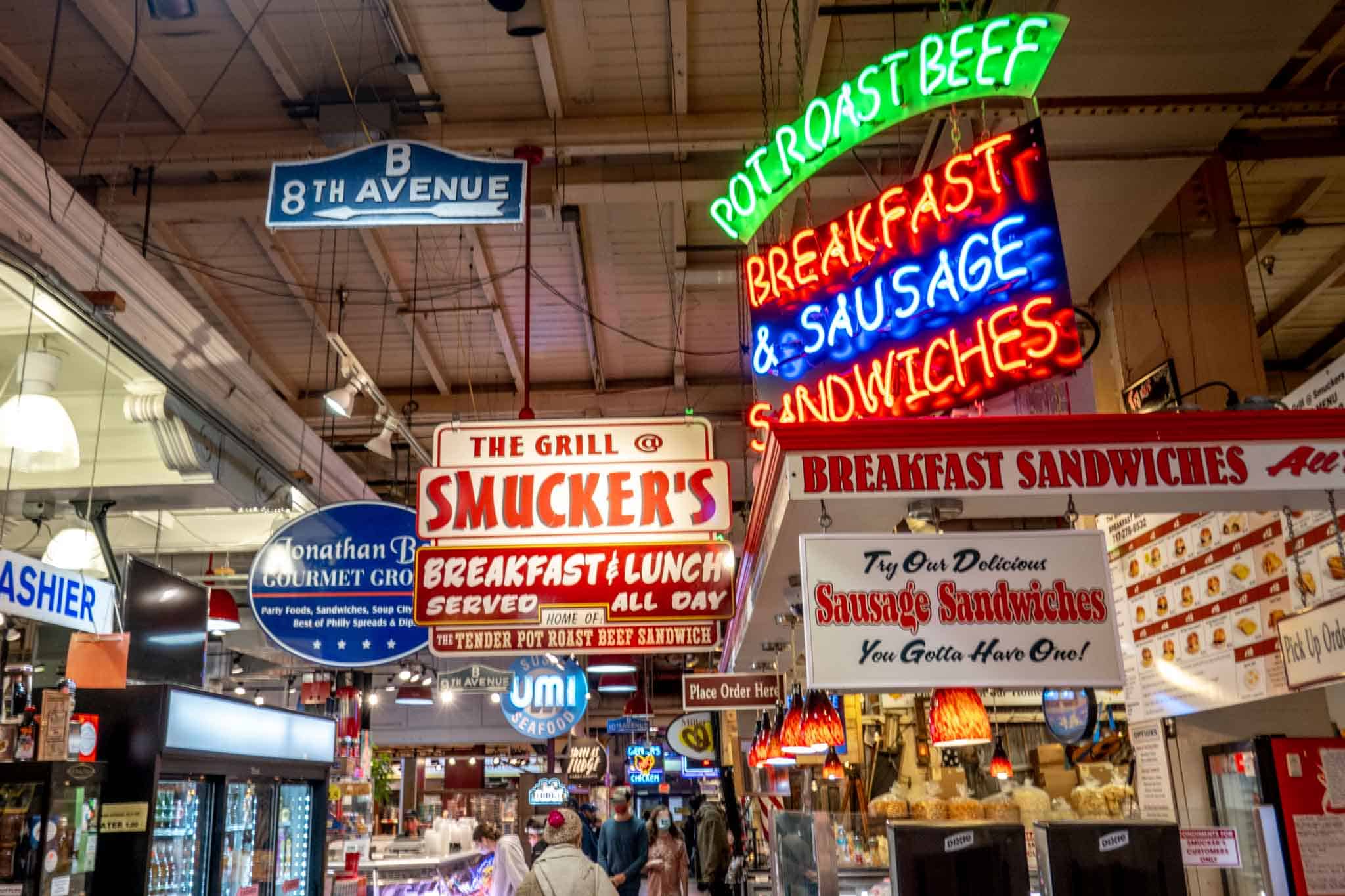 Signs for businesses in a food market.