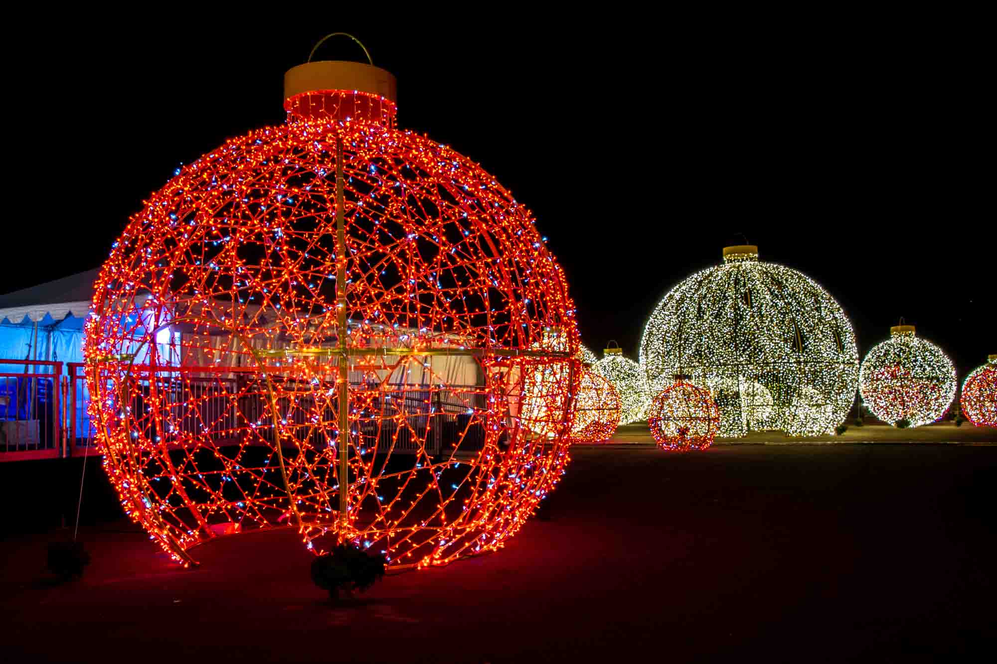 Giant red and white illuminated Christmas ornaments