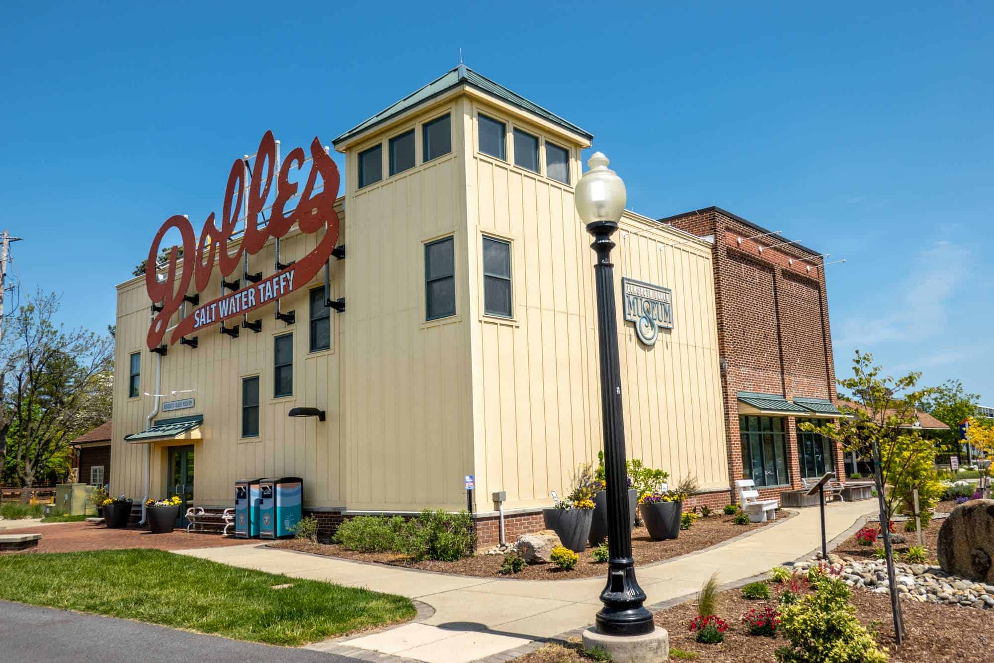 Yellow building with a red sign for "Dolle's Salt Water Taffy."