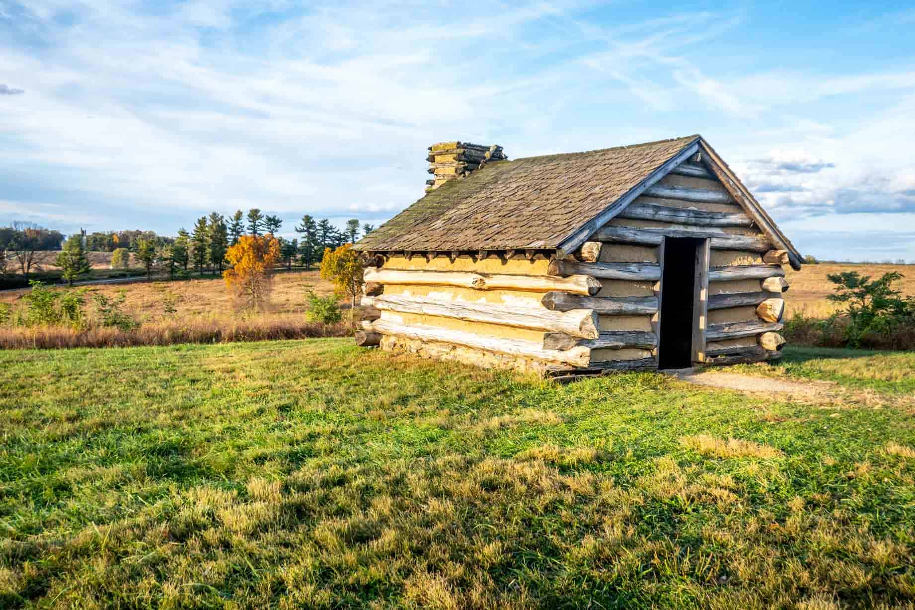 A long wood cabin in a field