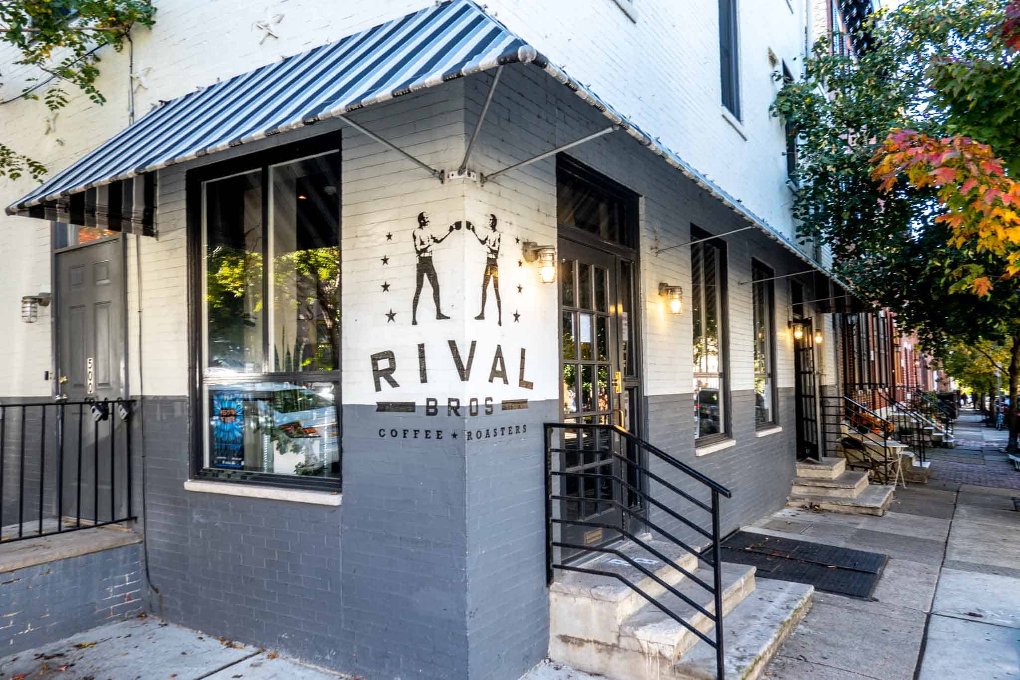 Exterior of a brick building with a sign for "Rival Bros Coffee Roasters."