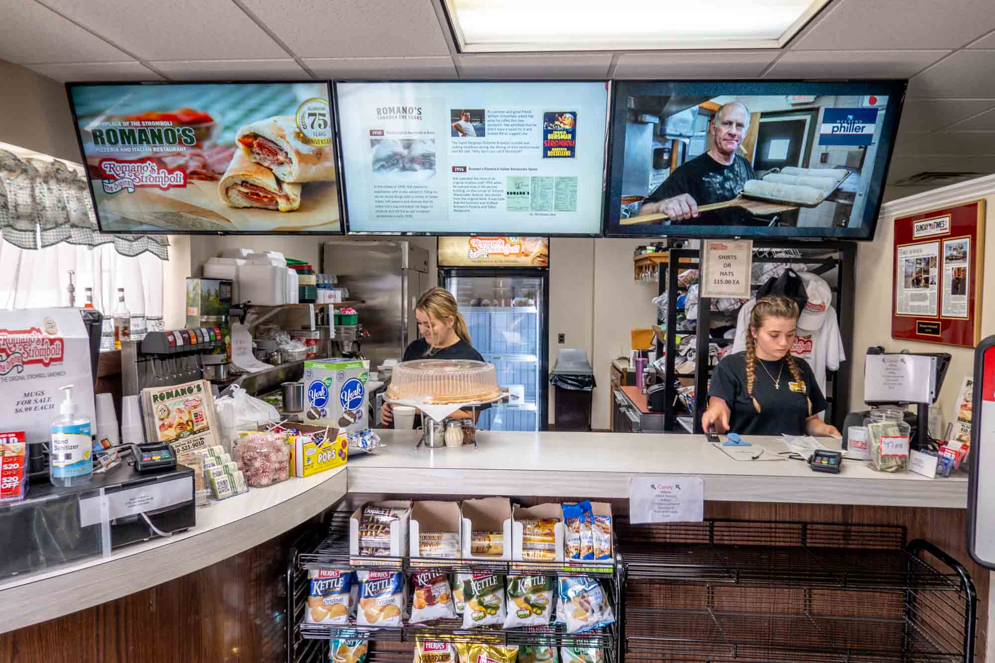 Workers at a counter in Romano's Stromboli restaurant