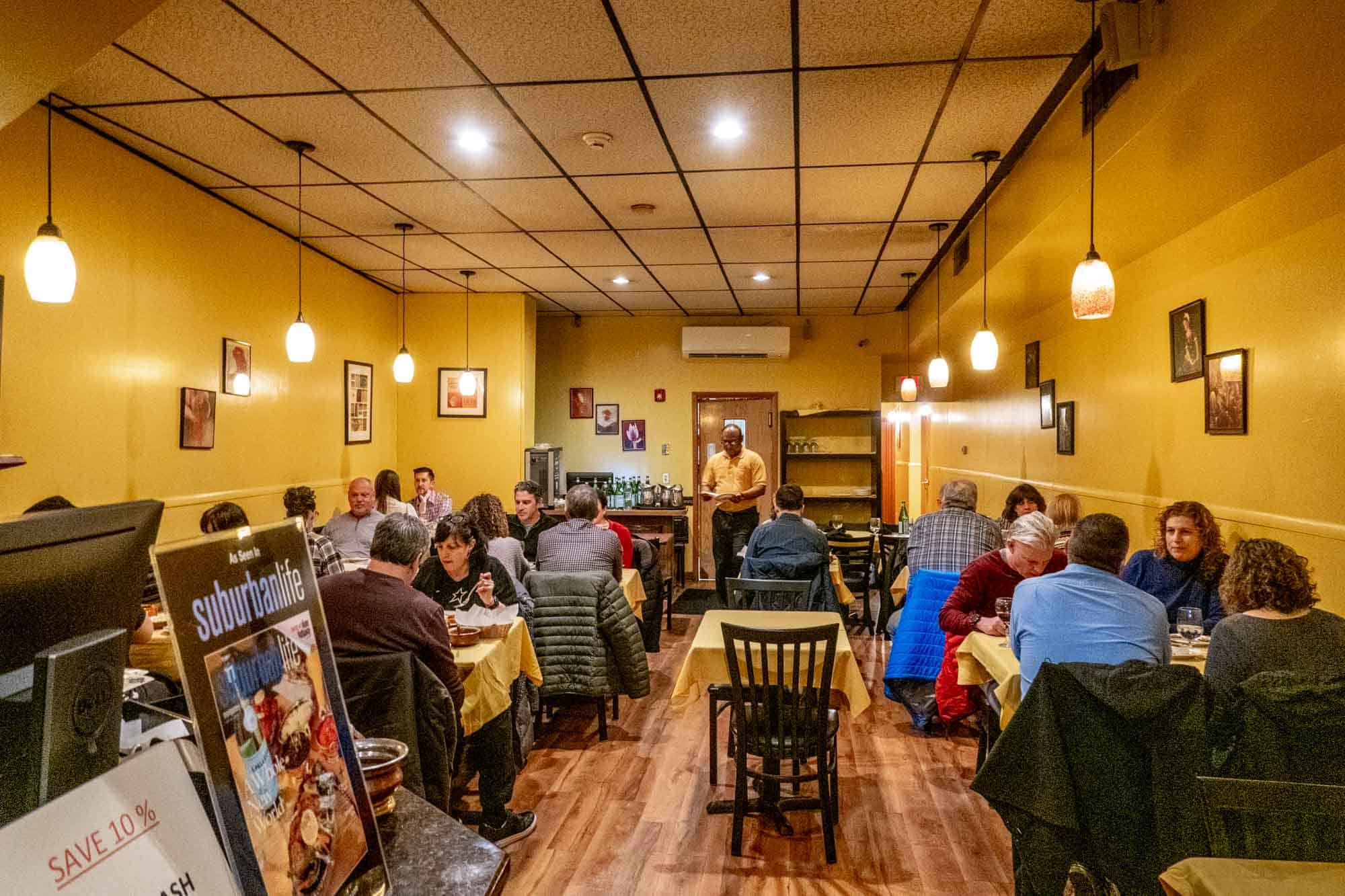 People dining in a restaurant with yellow walls