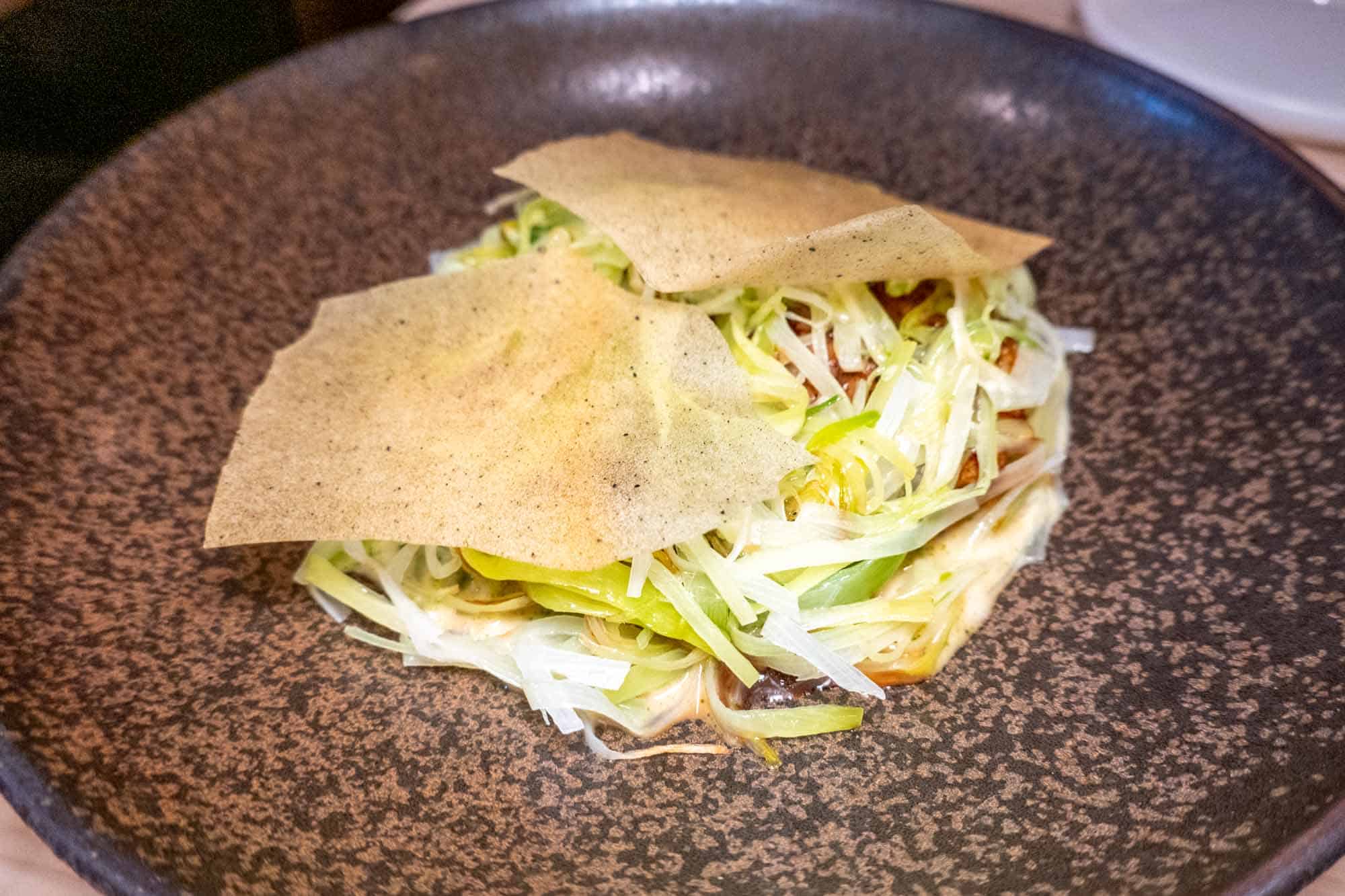 Filo dough chips covering shredded leeks and scallops