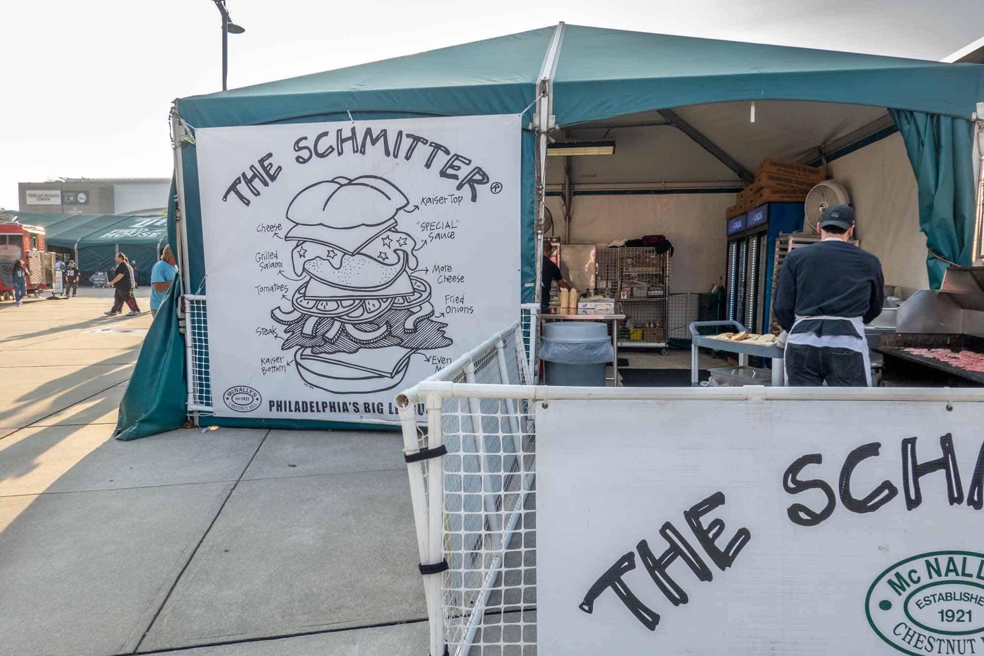 Food tent with sign reading "The Schmitter" and diagram on how to construct with the ingredients