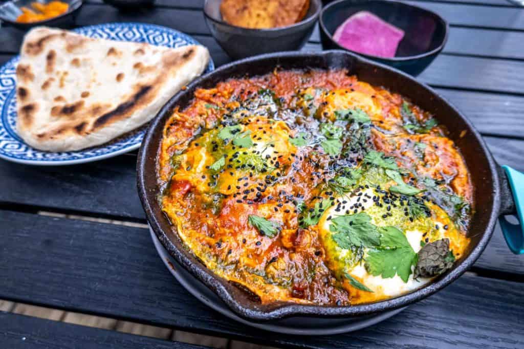 Shakshuka and pita on a table at a restaurant in Rittenhouse Square