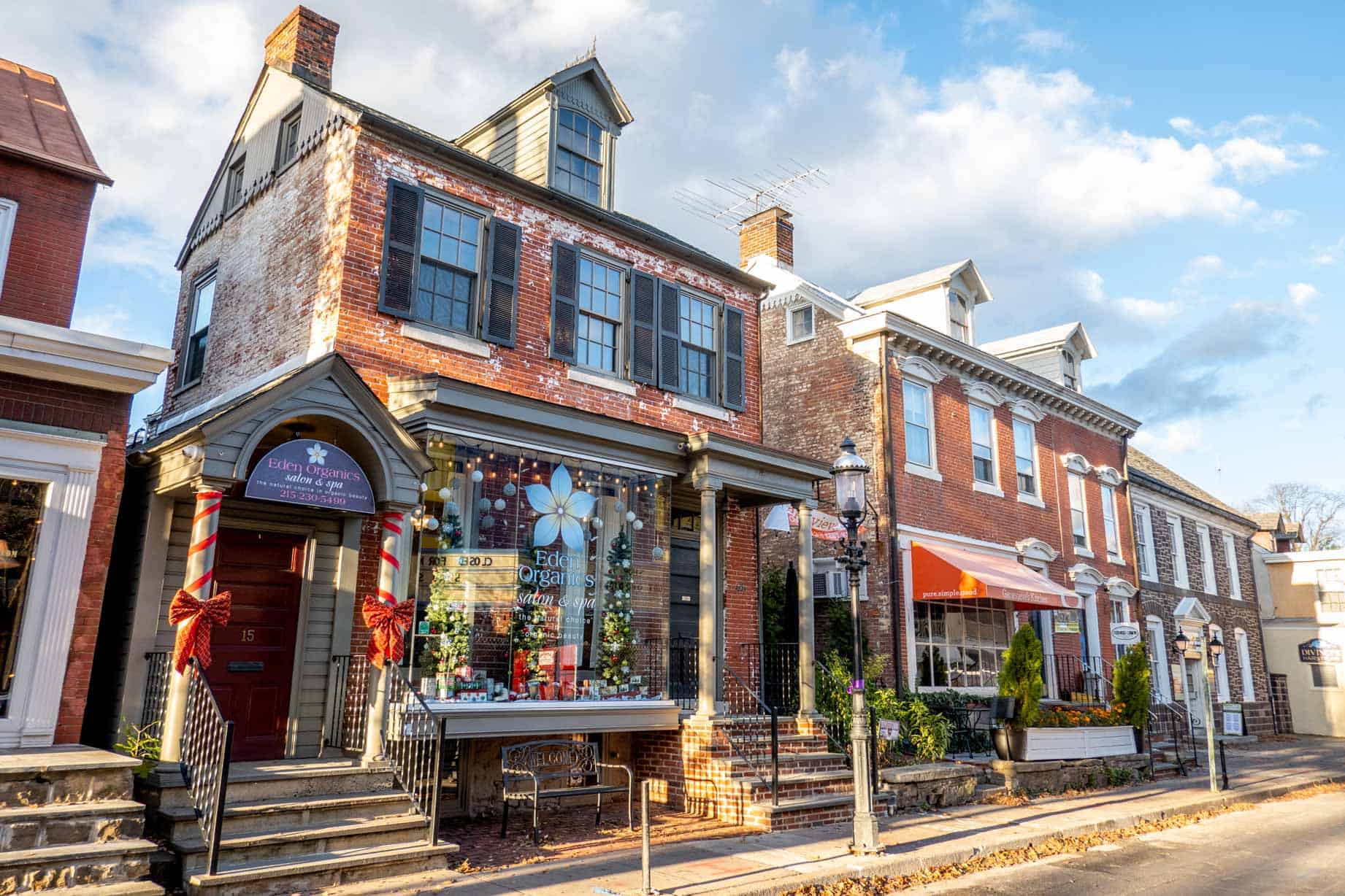 A row of stores in brick buildings along a street.