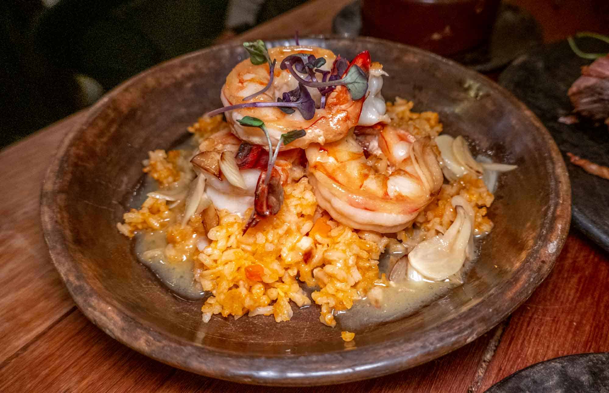 Shrimp, garlic and chilis over rice in a wood bowl at Sor Ynez