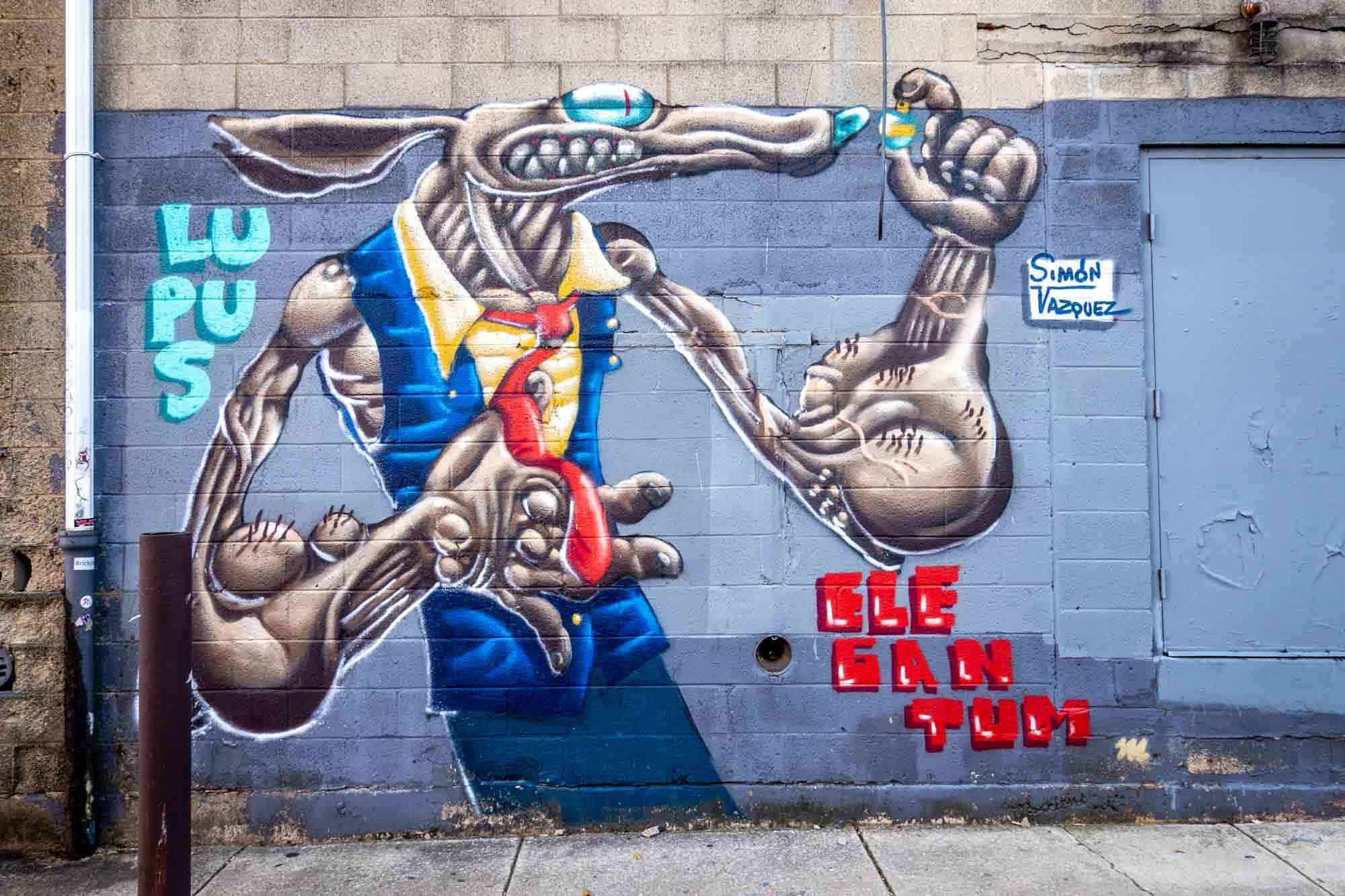 Street art mural of a rat-like creature wearing a vest and tie 