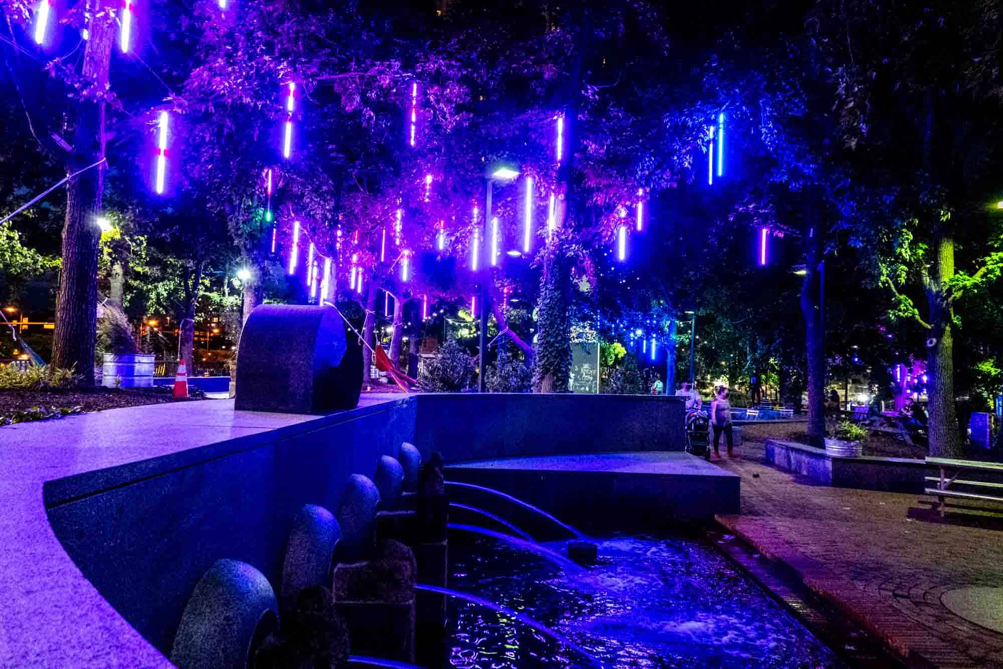 Fountain at night with blue lights.