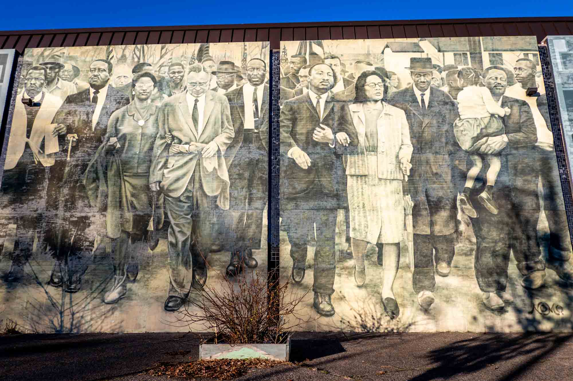Mural with numerous people walking, including Martin Luther King Jr. and Coretta Scott King
