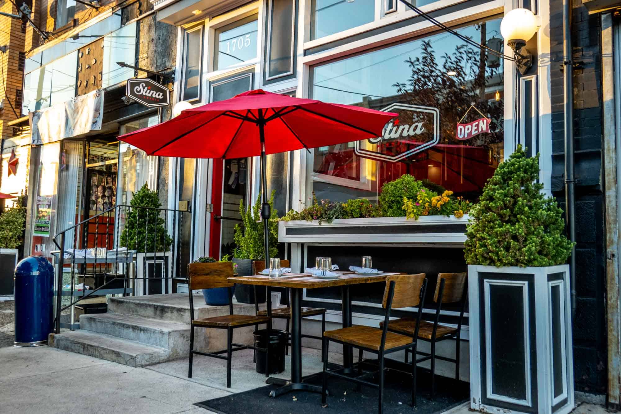 Outdoor table with umbrella at pizzeria Stina in South Philly