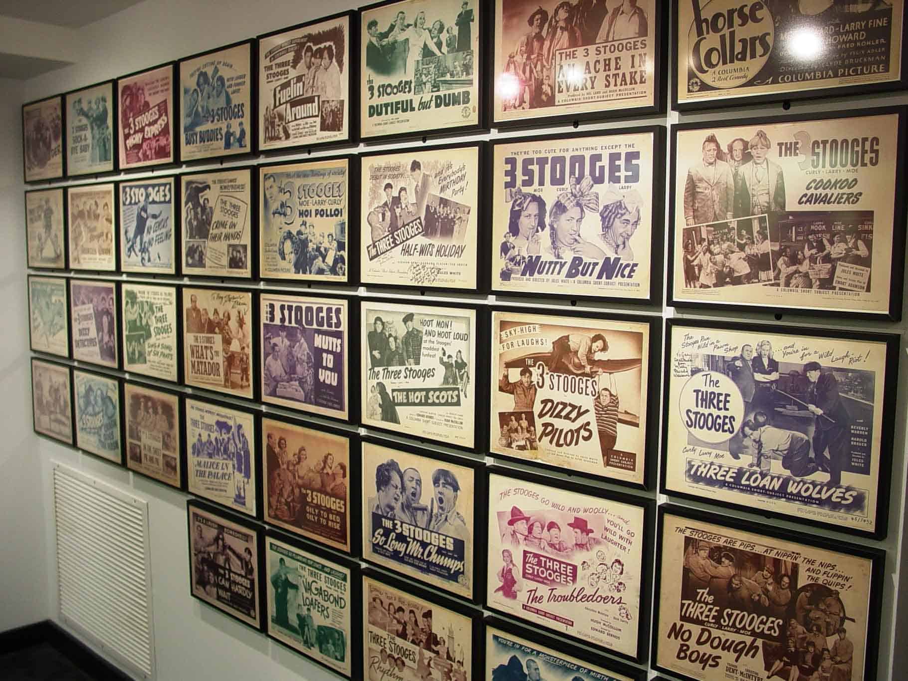 A wall of framed promotional posters