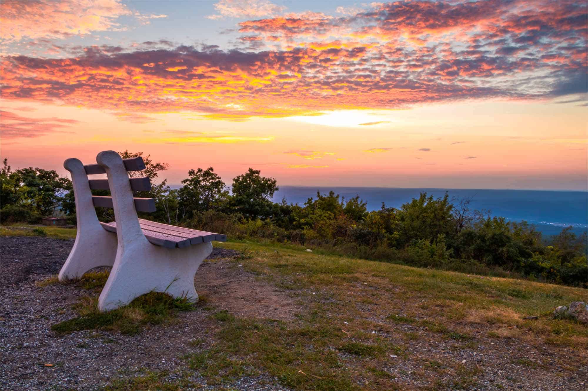 Park bench at sunset on mountain
