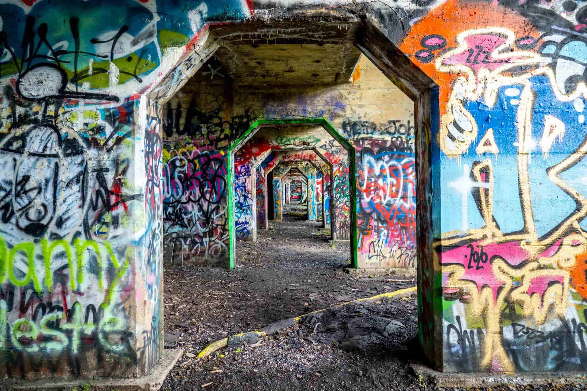 Spray painted tags on support columns at the pier