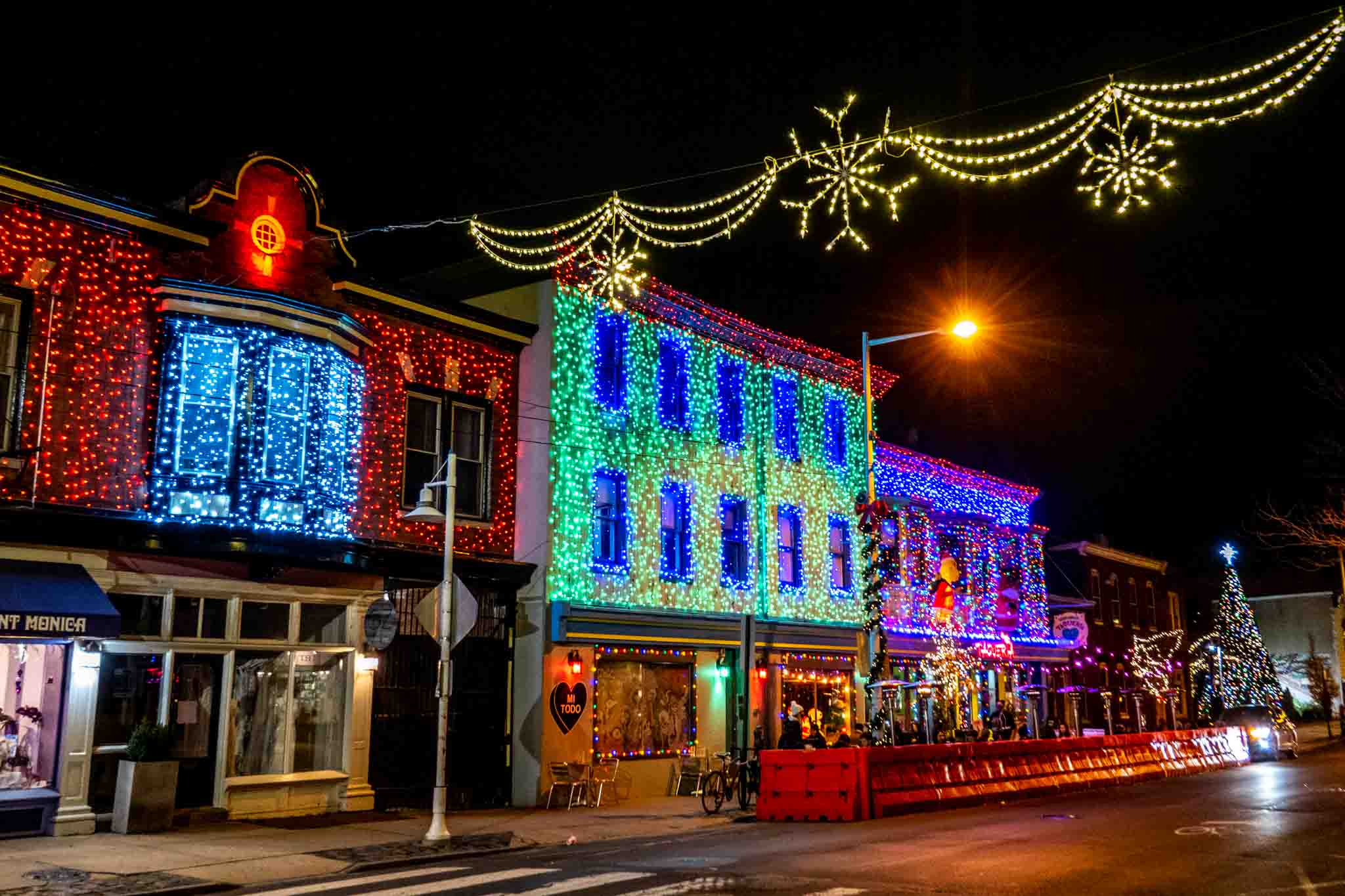 Buildings covered in Christmas lights at night