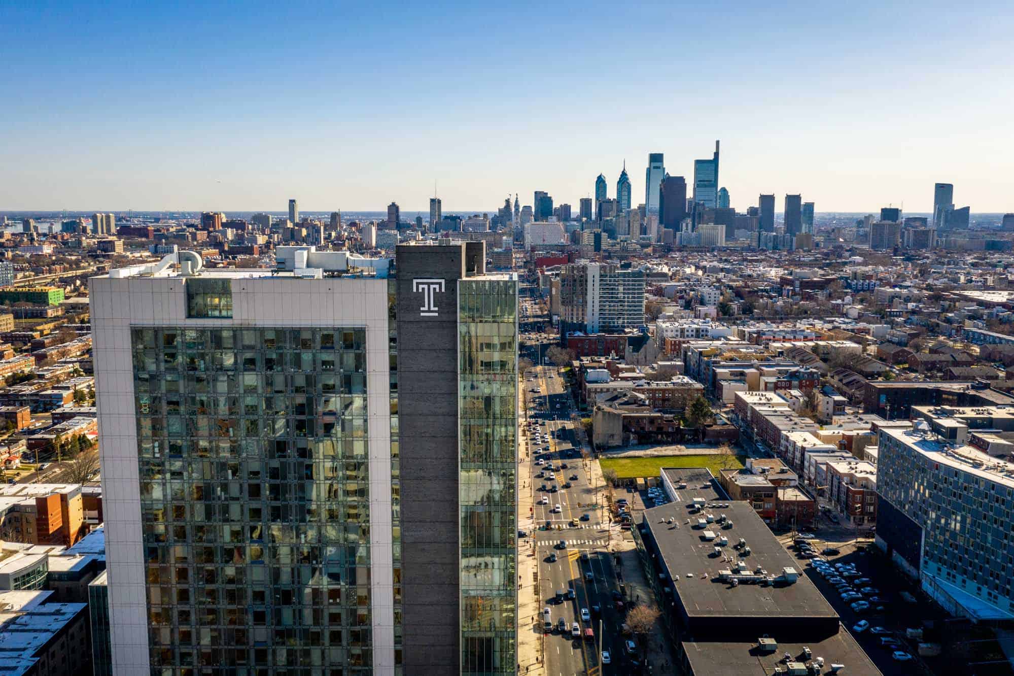 High rise tower with T and Philadelphia skyline