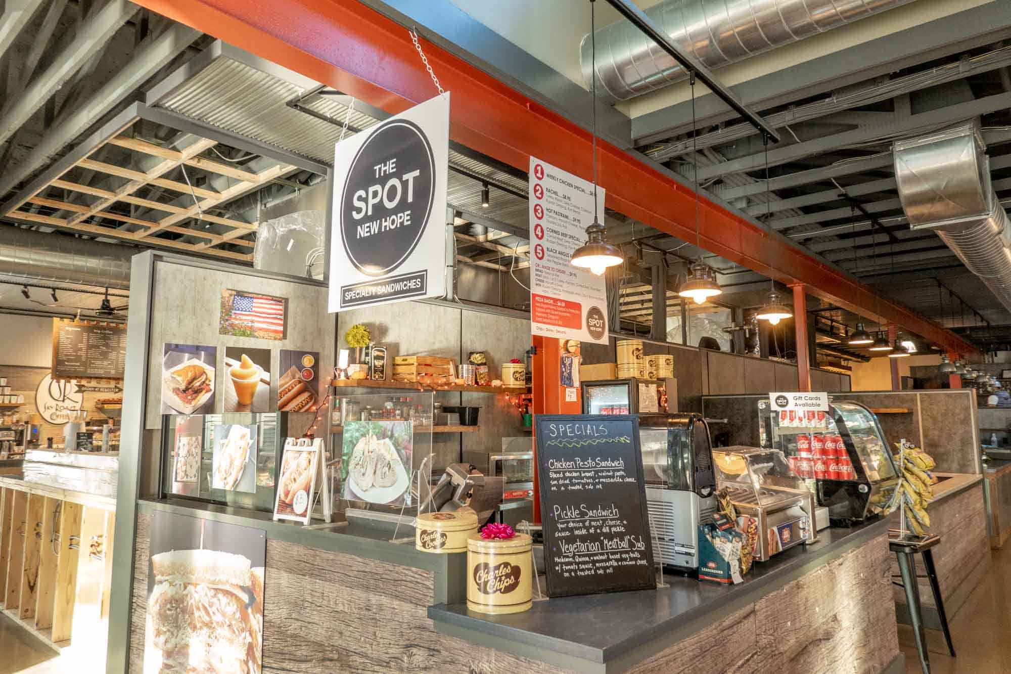 Counter of a sandwich shop inside a larger food hall