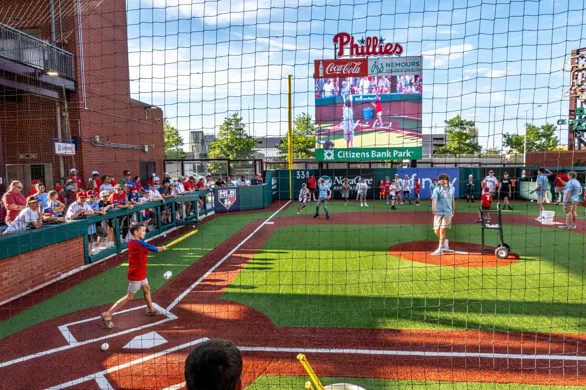 Kids playing Wiffle ball on a replica baseball diamond