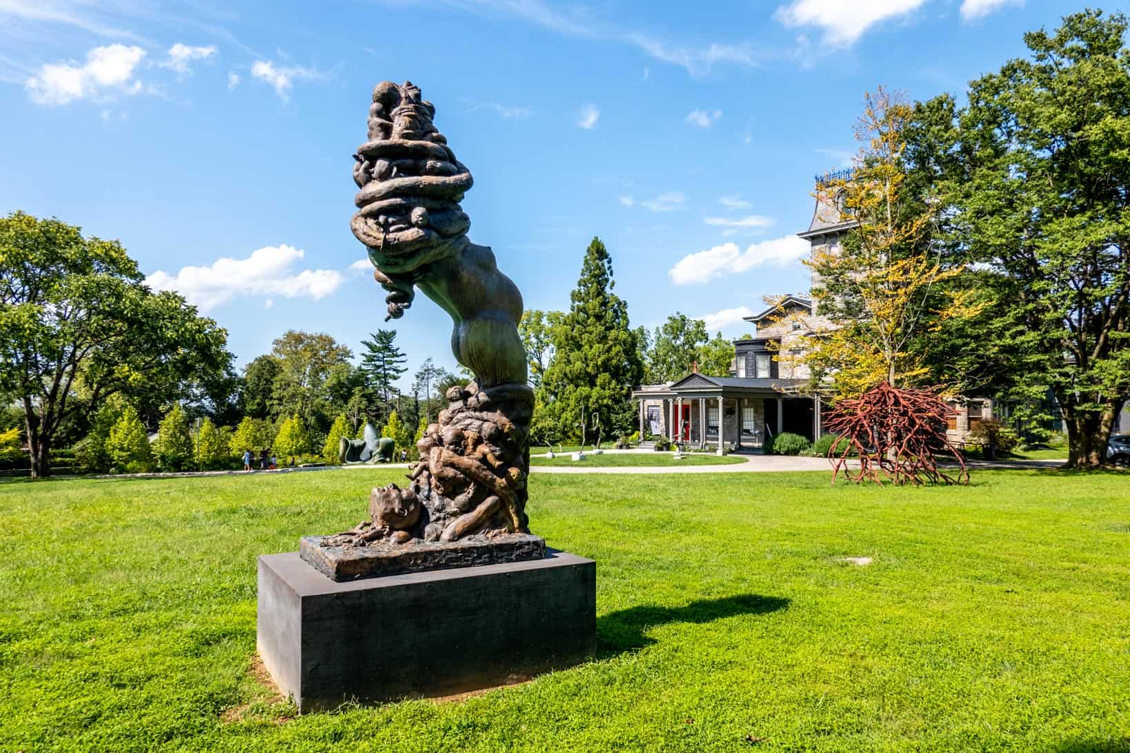 Abstract statue with human torso on the grounds of an art museum