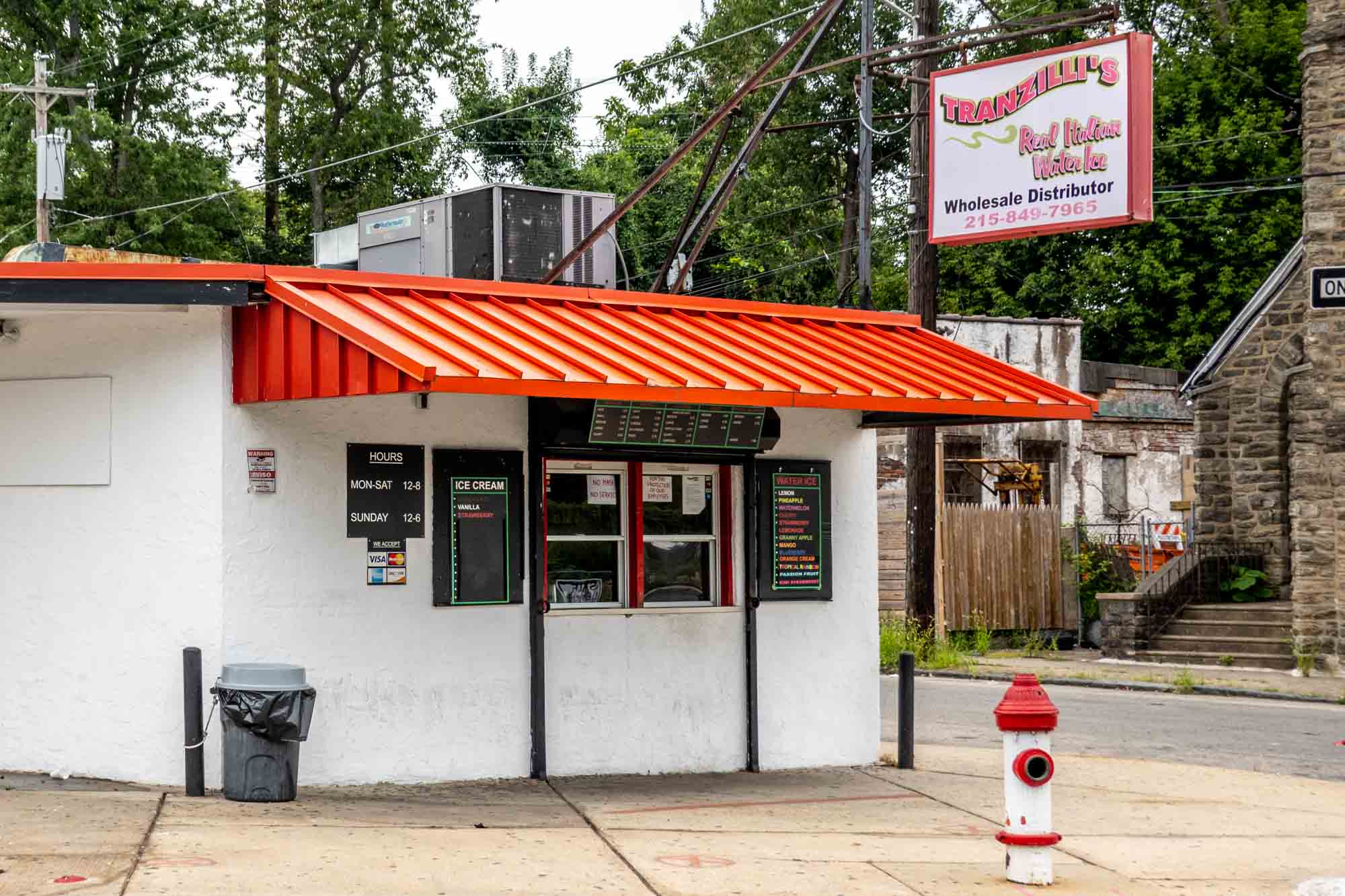 White storefront with red awning and sign: "Tranzilli's Real Italian Water Ice."