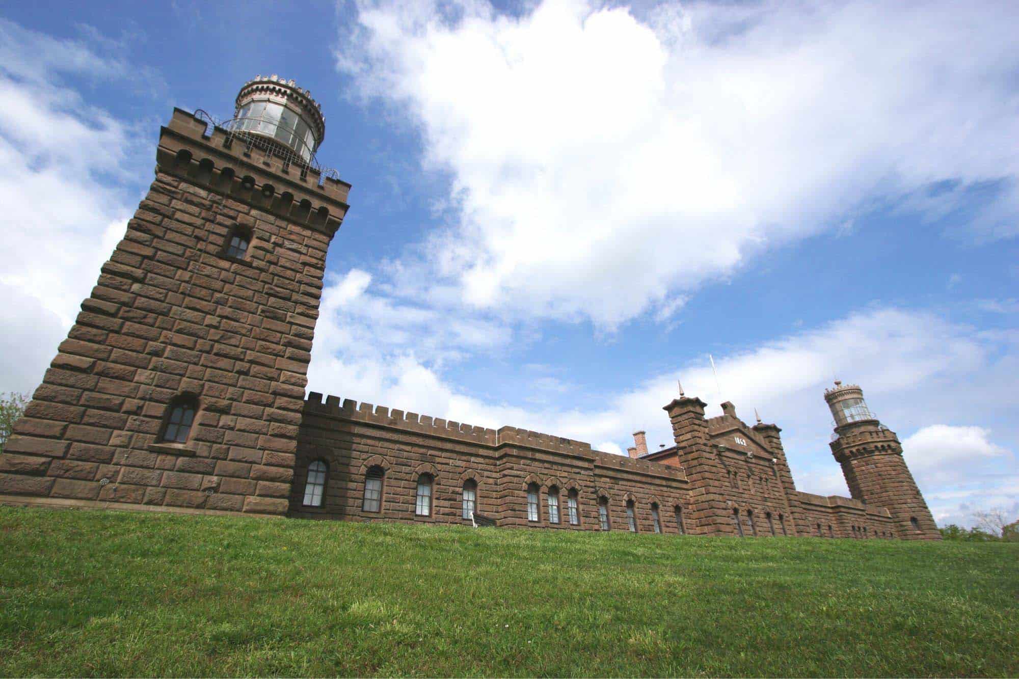Twin lighthouses at a fortress-looking building