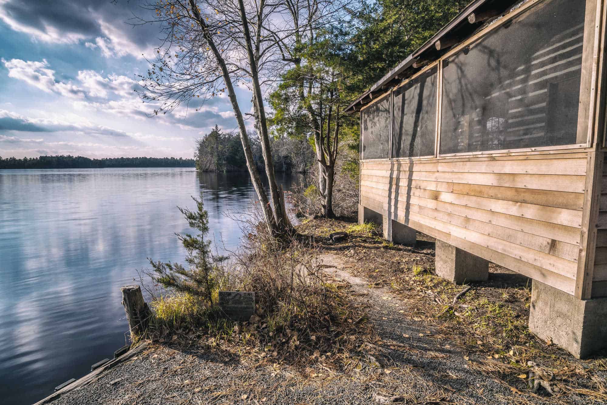 Wooden cabin along shore of lake