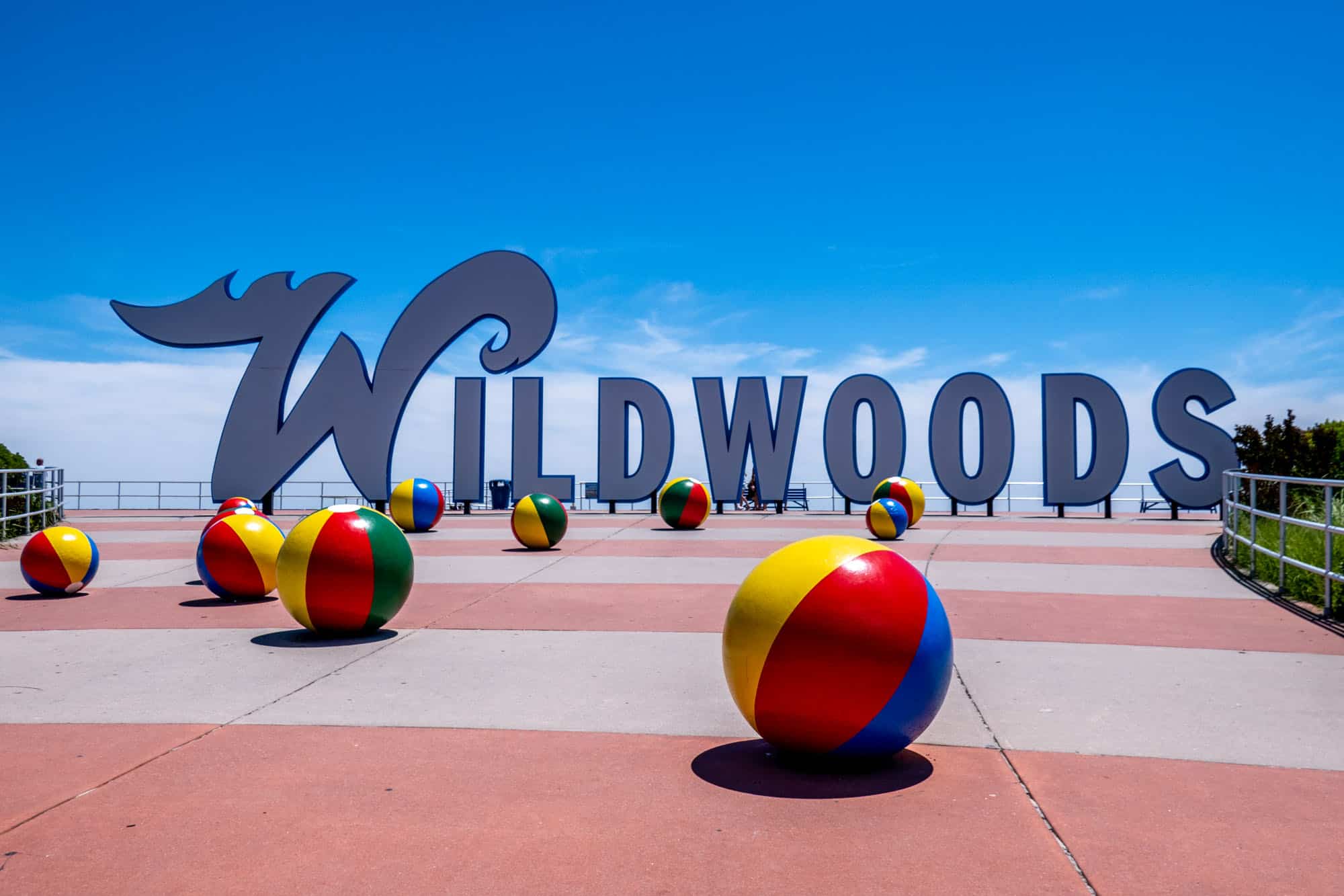 The "Wildwoods" sign with colorful beach balls on the sidewalk