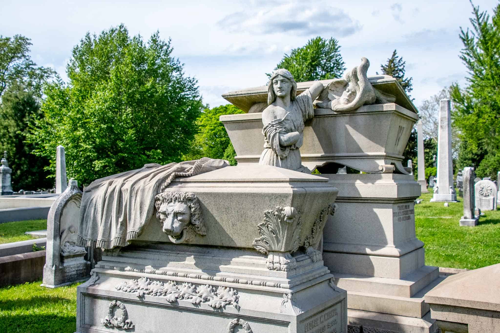 Tomb with a sculpture of a woman opening the lid to let the spirit out