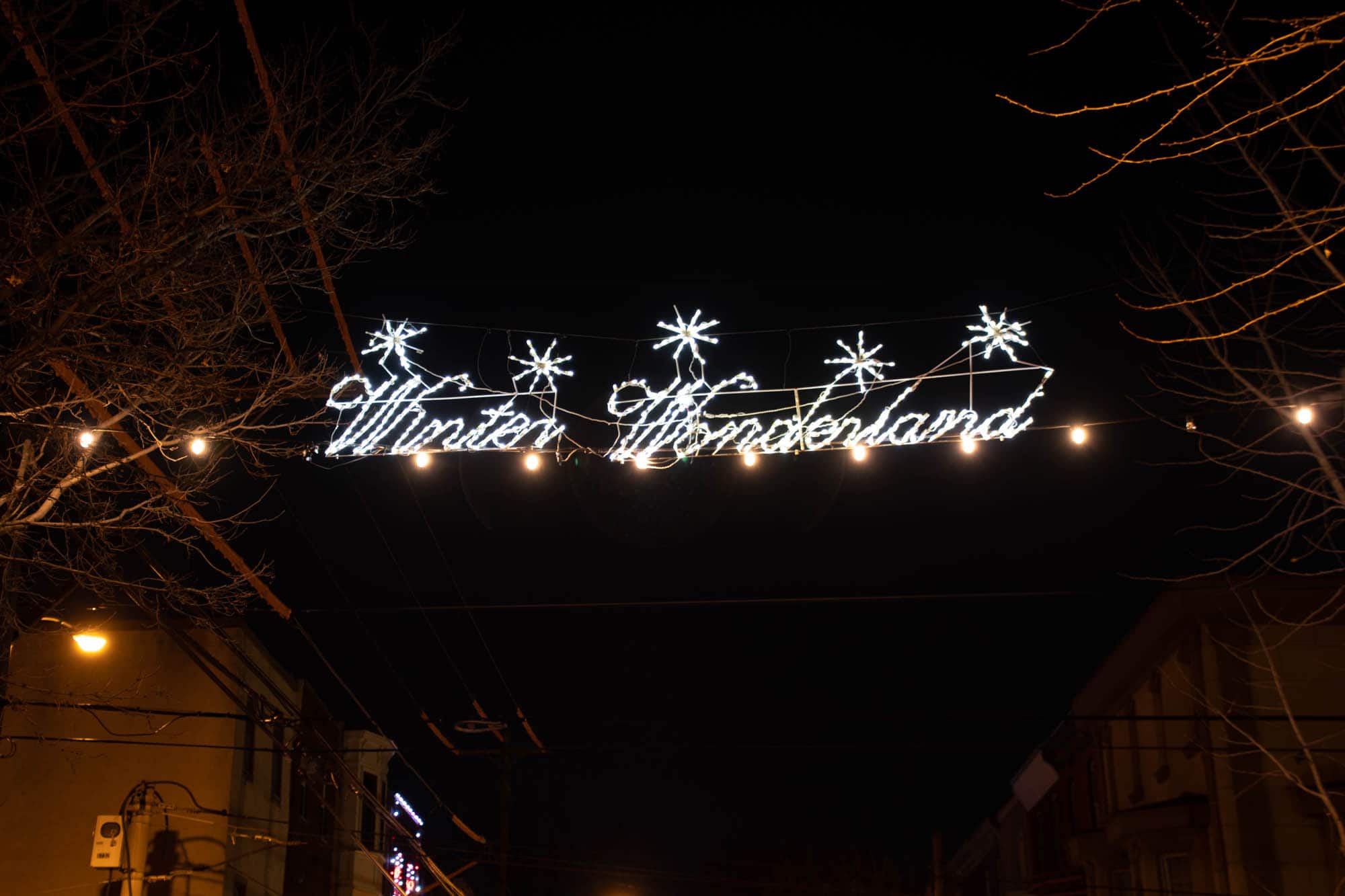 Illuminated sign over street reading 'Winter Wonderland'
