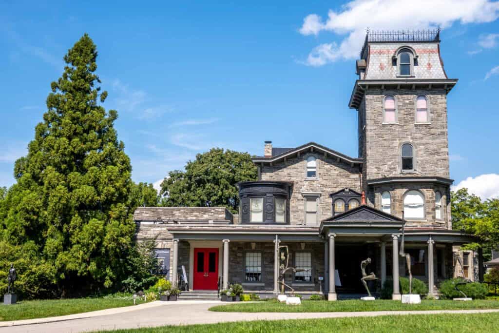A Victorian home, Woodmere museum, with sculptures in the front yard.