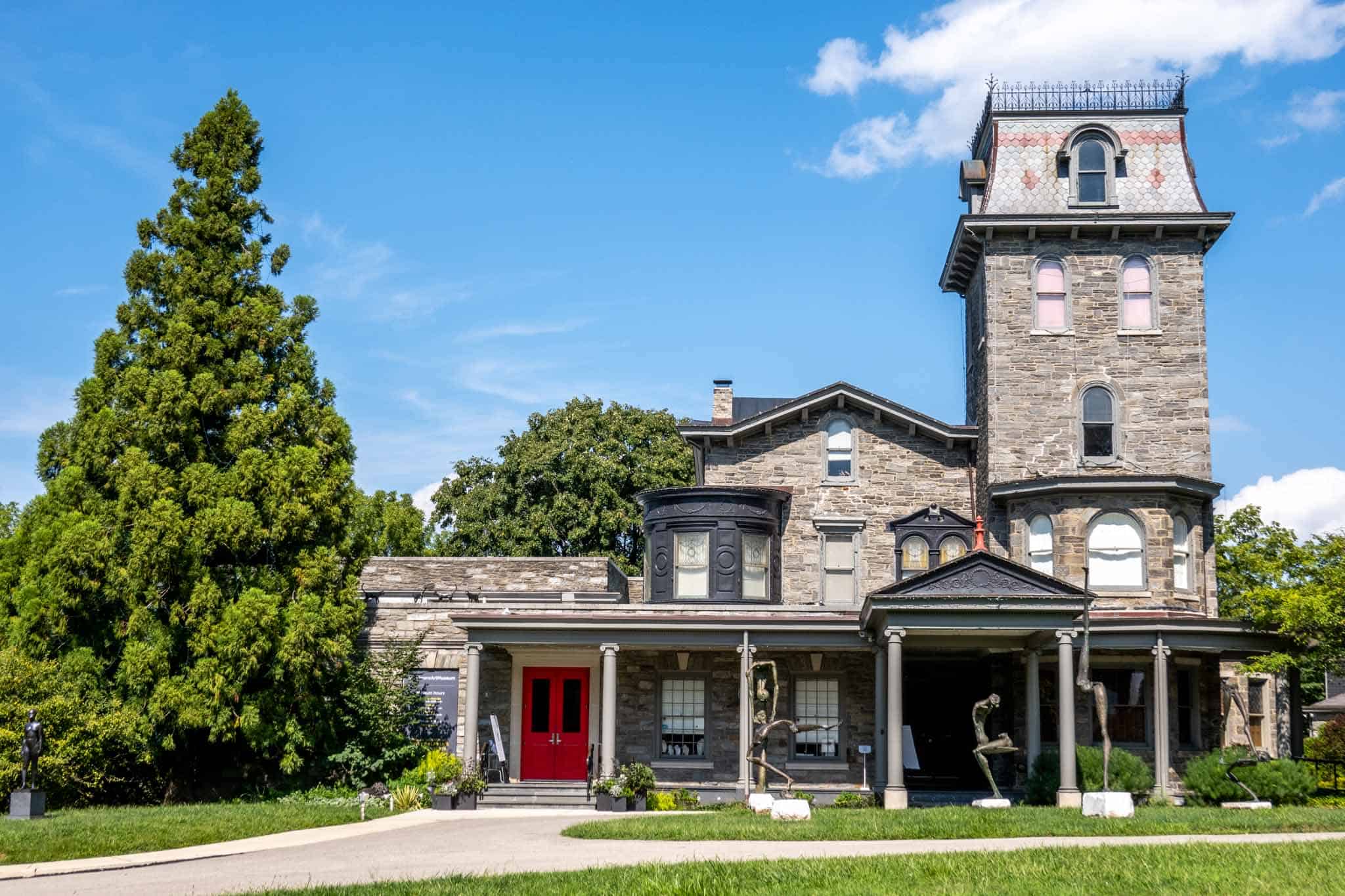 A Victorian home, Woodmere museum, with sculptures in the front yard. 