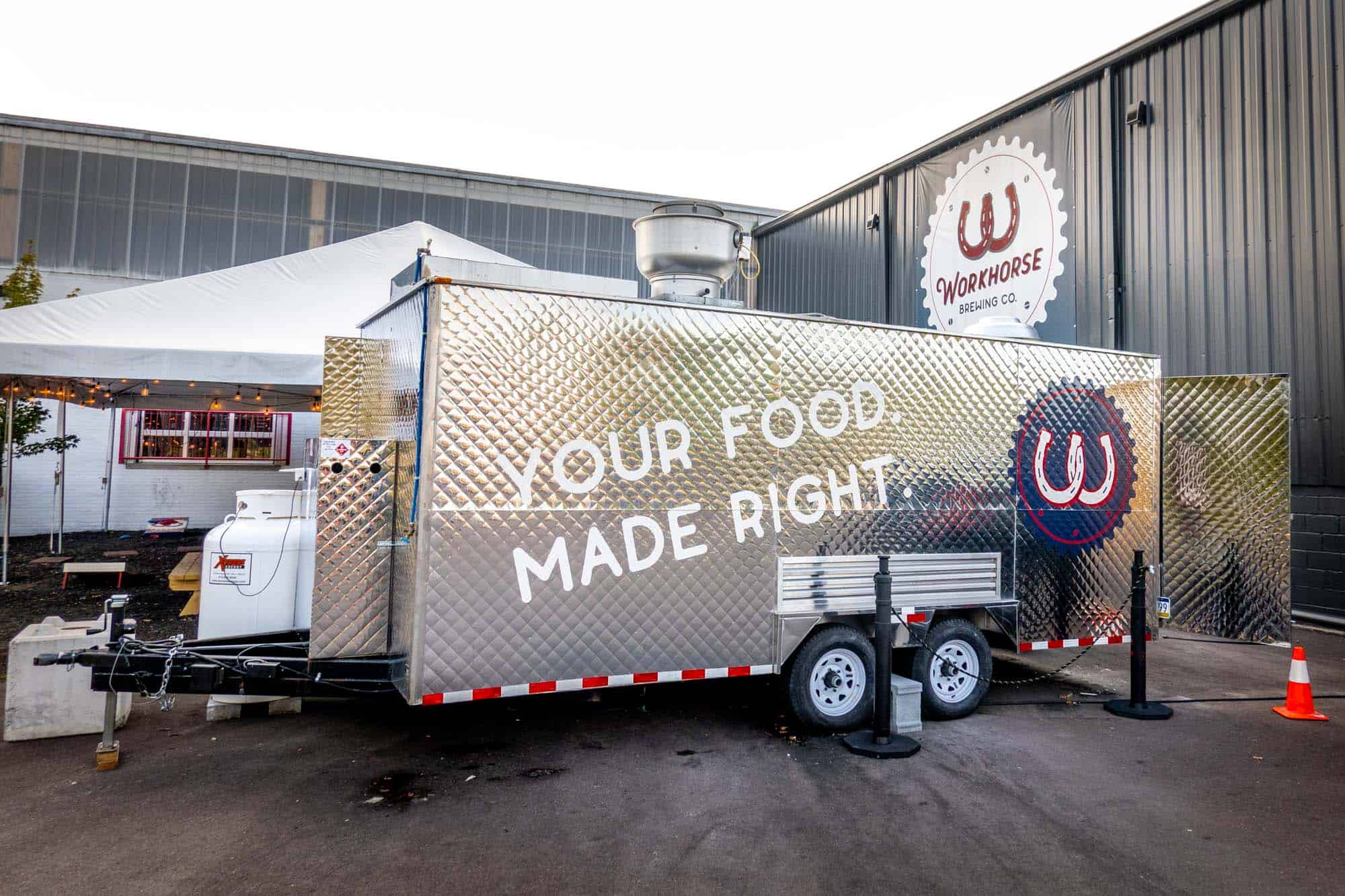 Food truck saying "Your Food. Made Right" in front of Workhouse sign